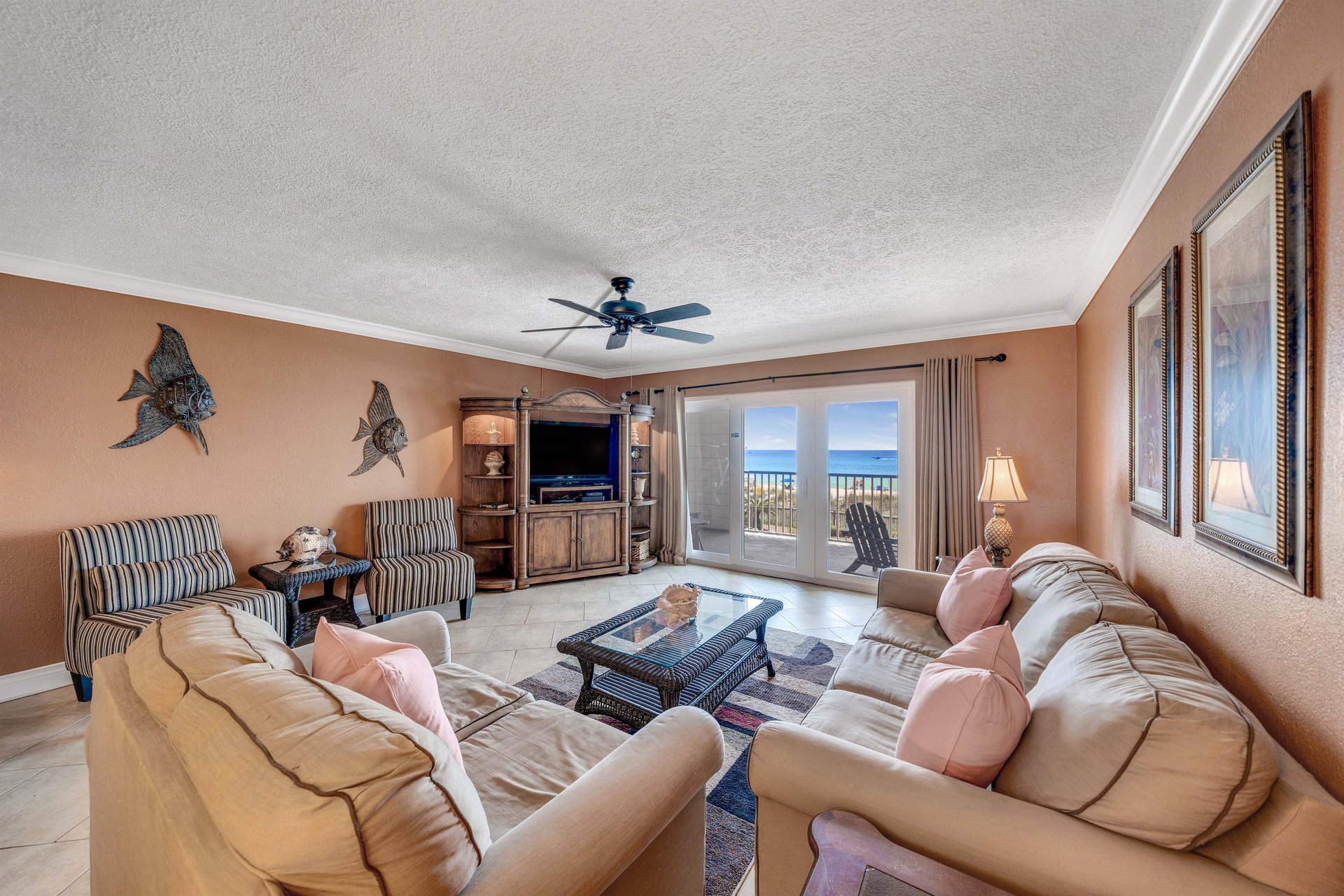 The living room offers ample, comfortable seating, a flat screen television, and beautiful views of the beach.