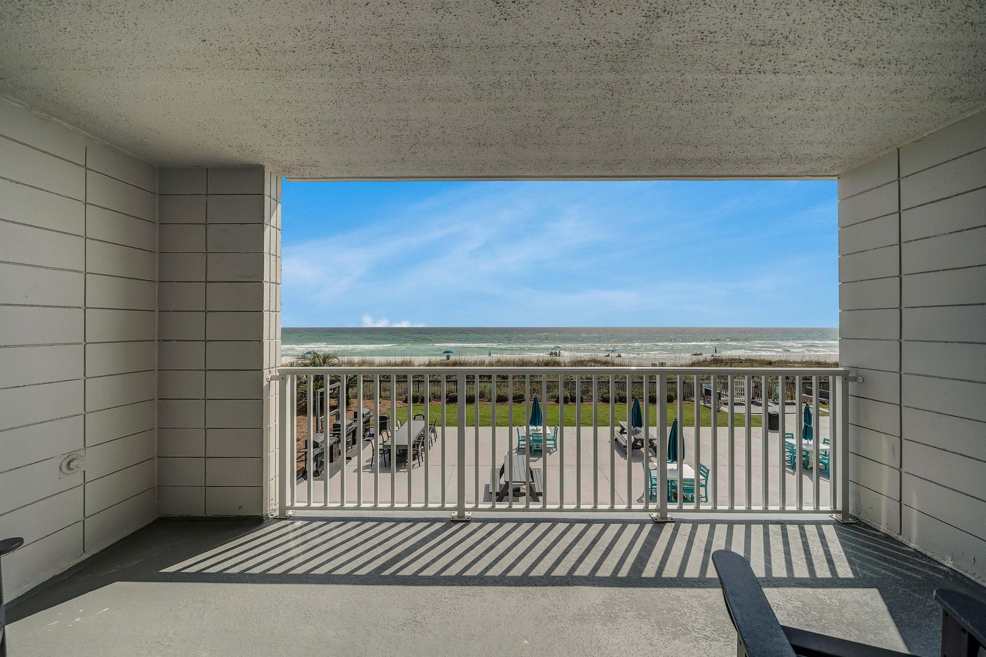 Step onto your spacious private balcony overlooking the beach and the pool.