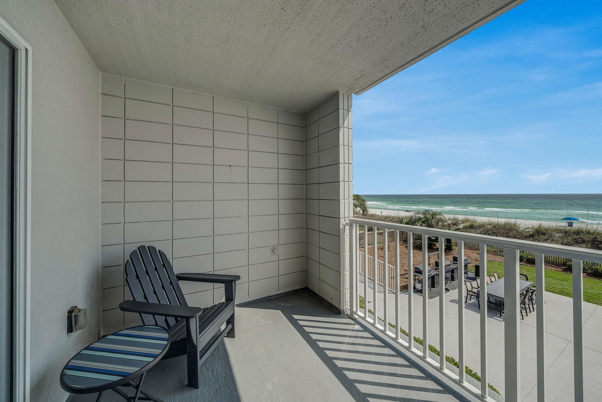 Step onto your spacious private balcony overlooking the beach and the pool.