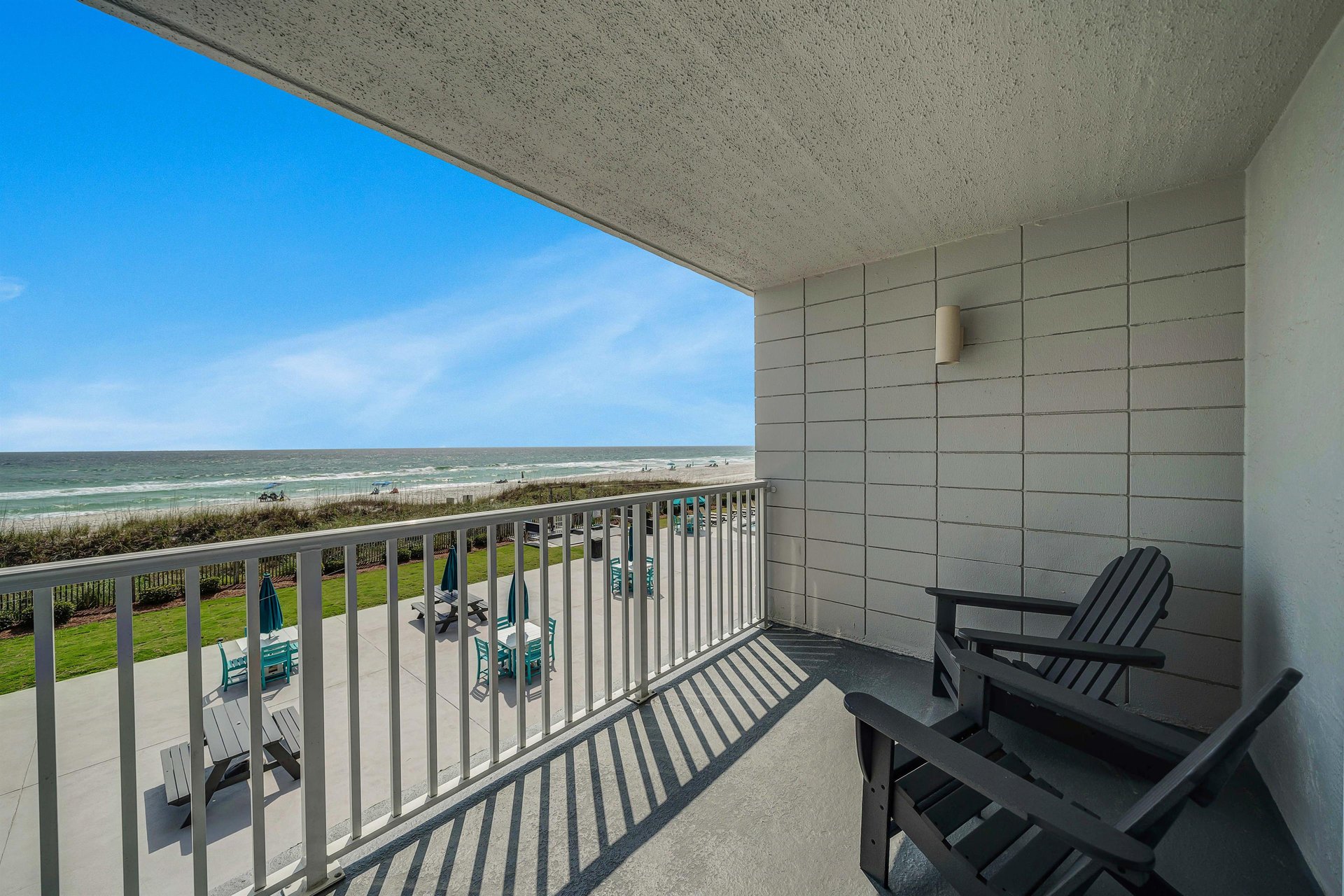 Step onto your spacious private balcony overlooking the beach and the pool.