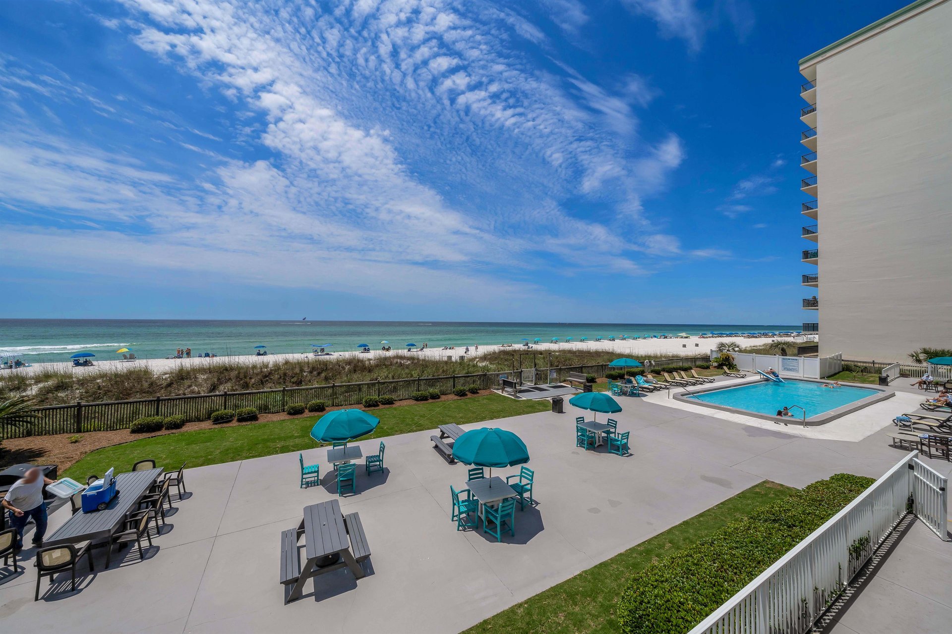 Step onto your spacious private balcony overlooking the beach and the pool.