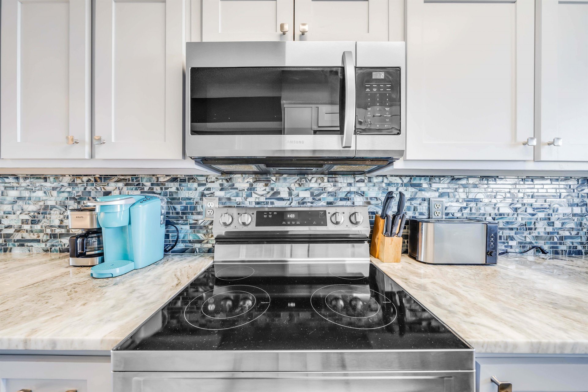 The updated, fully equipped kitchen features quartz countertops, stainlesssteel appliances, and has everything you need to prepare meals for family  friends.
