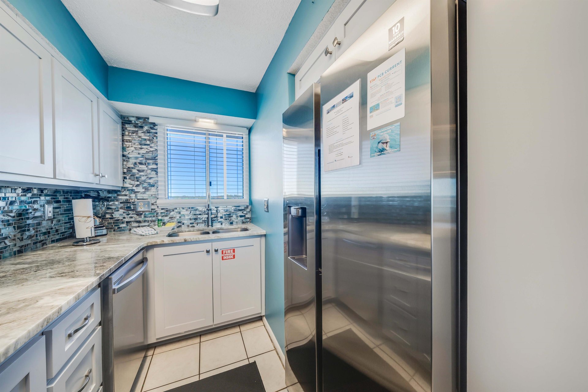 The updated, fully equipped kitchen features quartz countertops, stainlesssteel appliances, and has everything you need to prepare meals for family  friends.