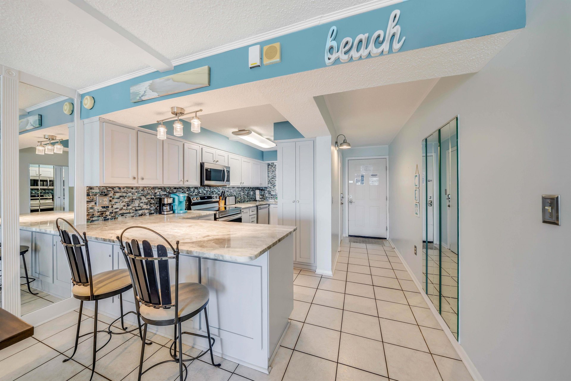 There is a dining table, perfect for enjoying a meal or playing a game, as well as additional breakfast bar seating.