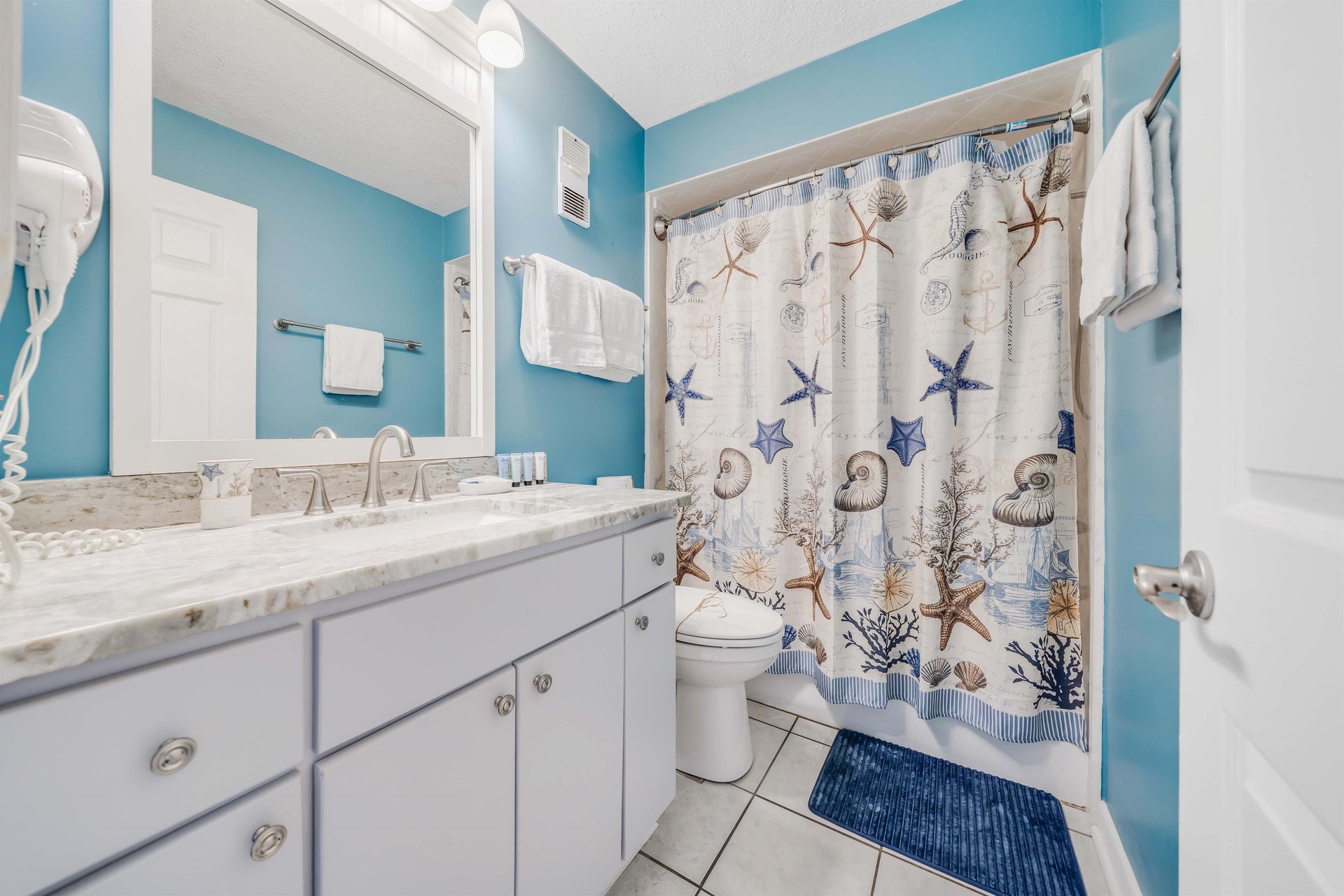The ensuite master bathroom features quartz countertops and a tubshower combo.