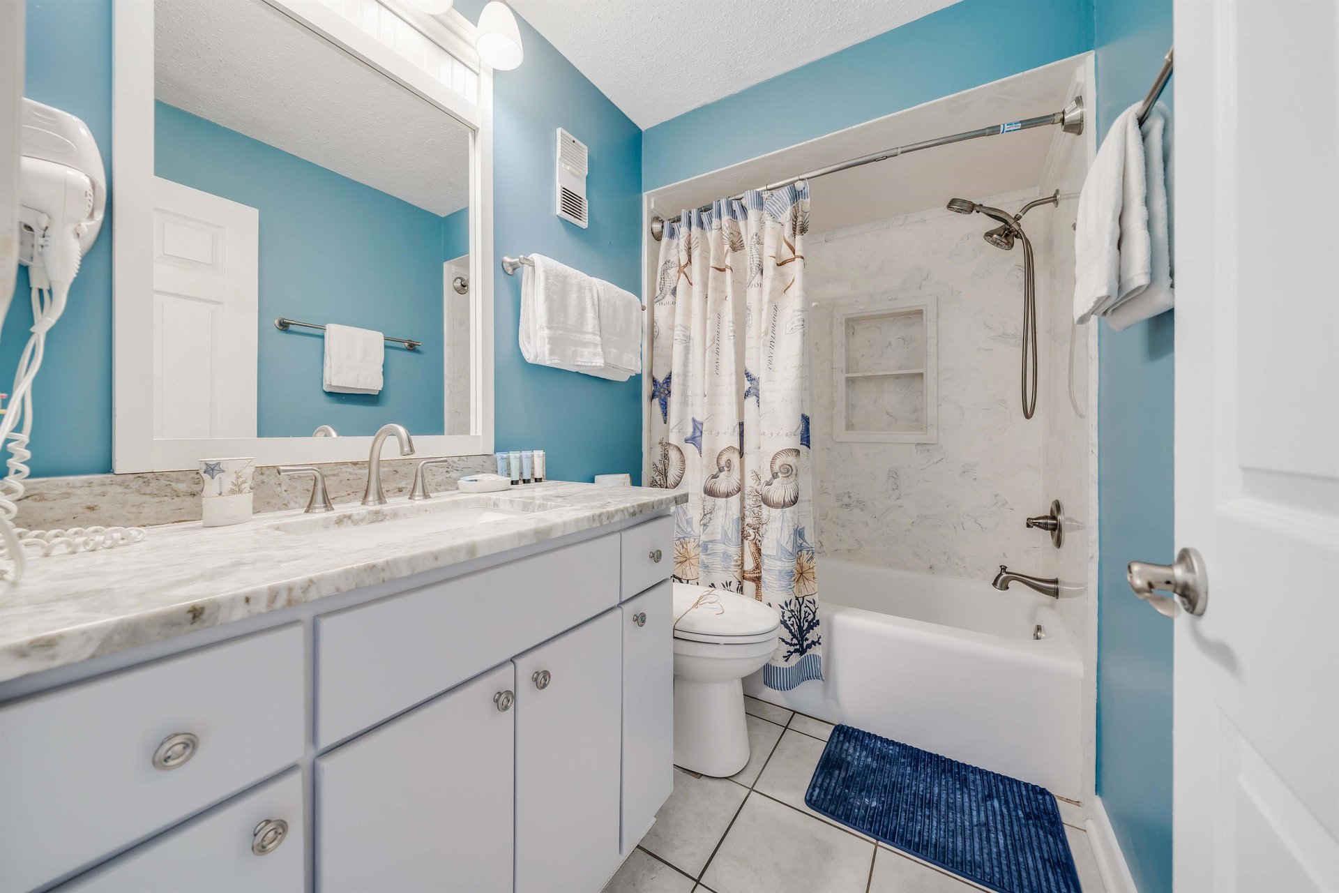 The ensuite master bathroom features quartz countertops and a tubshower combo.