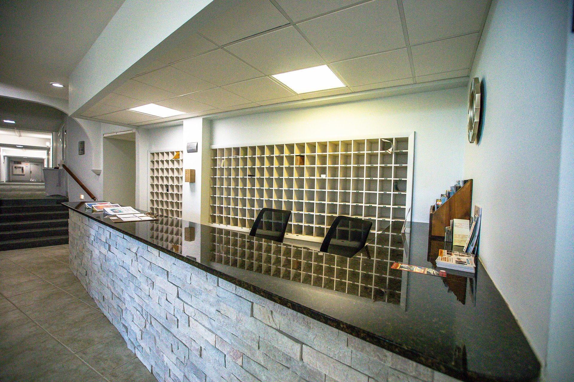 Modern reception desk with organized mail sorting system ensures smooth checkin and seamless communication throughout your stay.