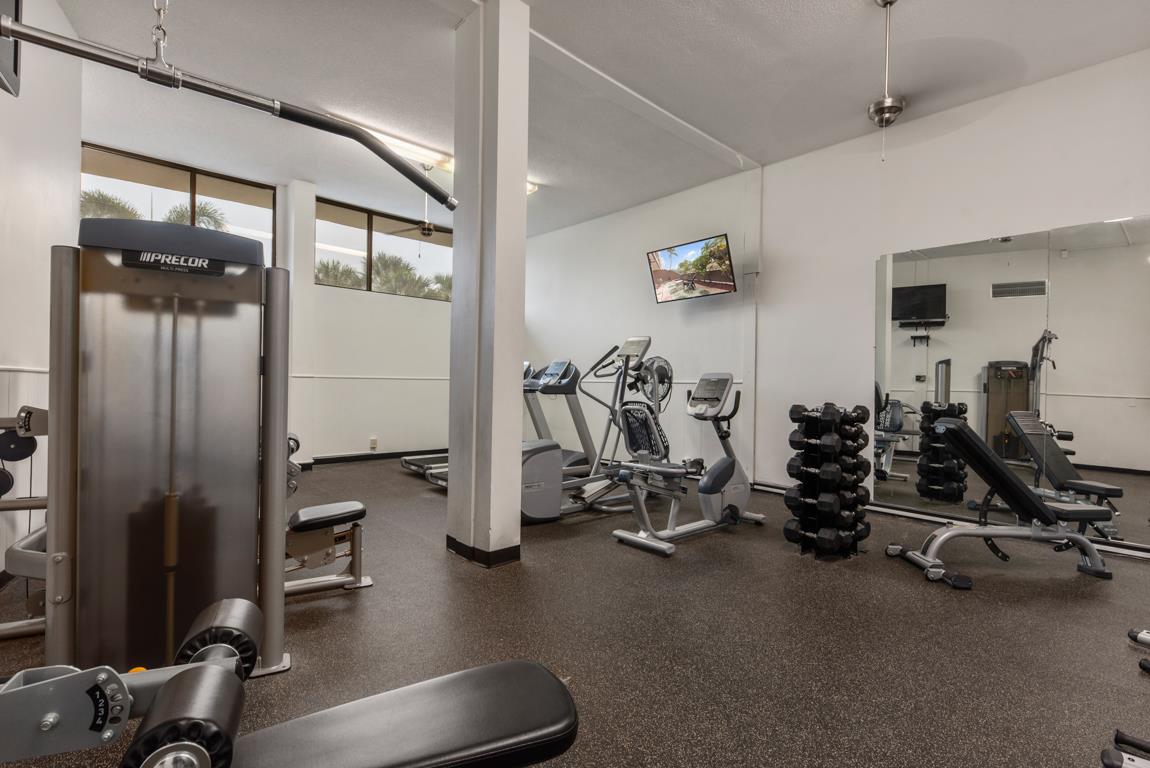 Your fitness goals await in this wellequipped gym, complete with modern cardio machines, free weights, and strength training equipment for your daily workout.