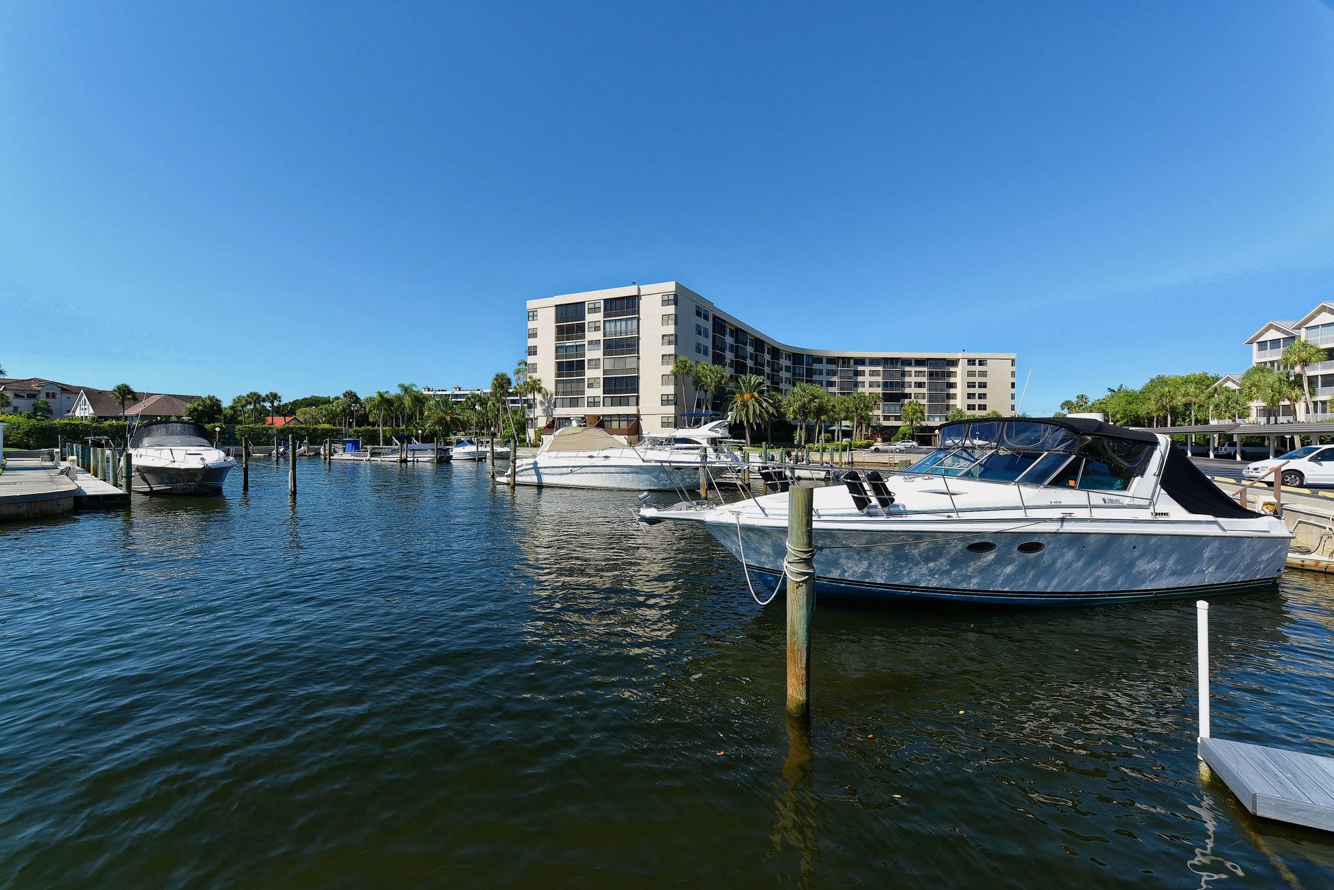 Waterfront property located on a peaceful marina with boats and tropical surroundings in a resortstyle community.