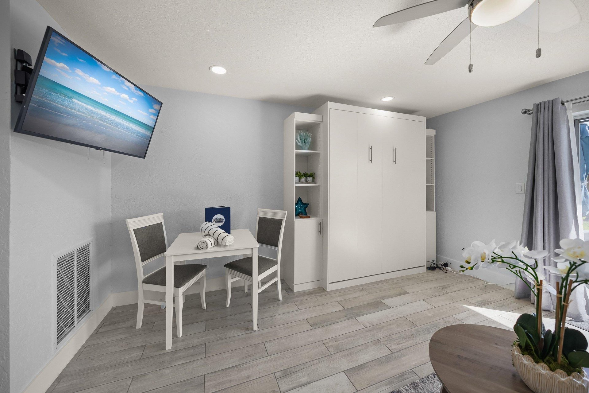 Your modern studio features a Murphy bed, dining nook, and wallmounted TV for comfortable relaxing after exploring.