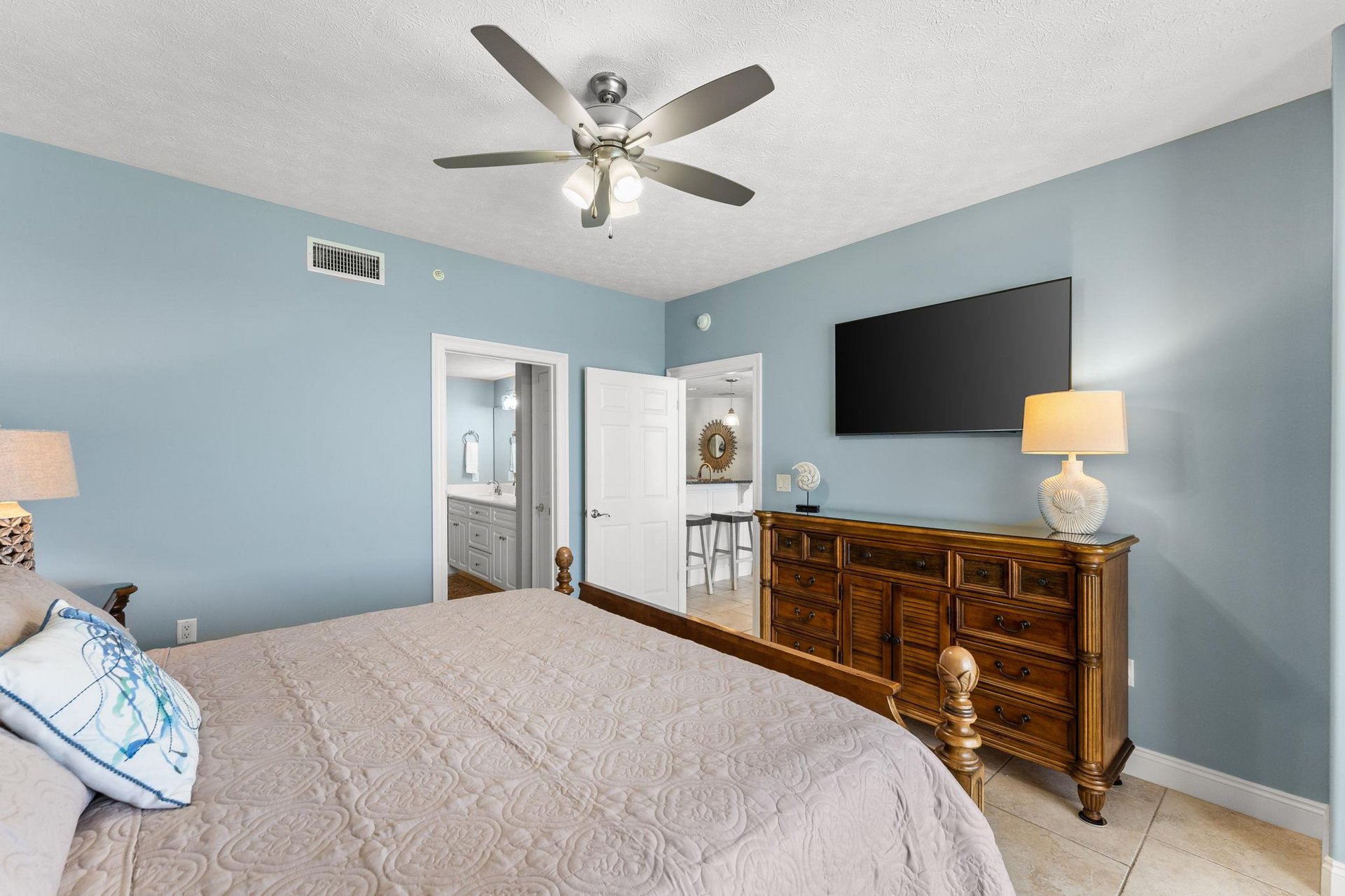 The gulf front master bedroom offers a Kingsized bed, a television, access to the balcony, and it own ensuite bathroom.