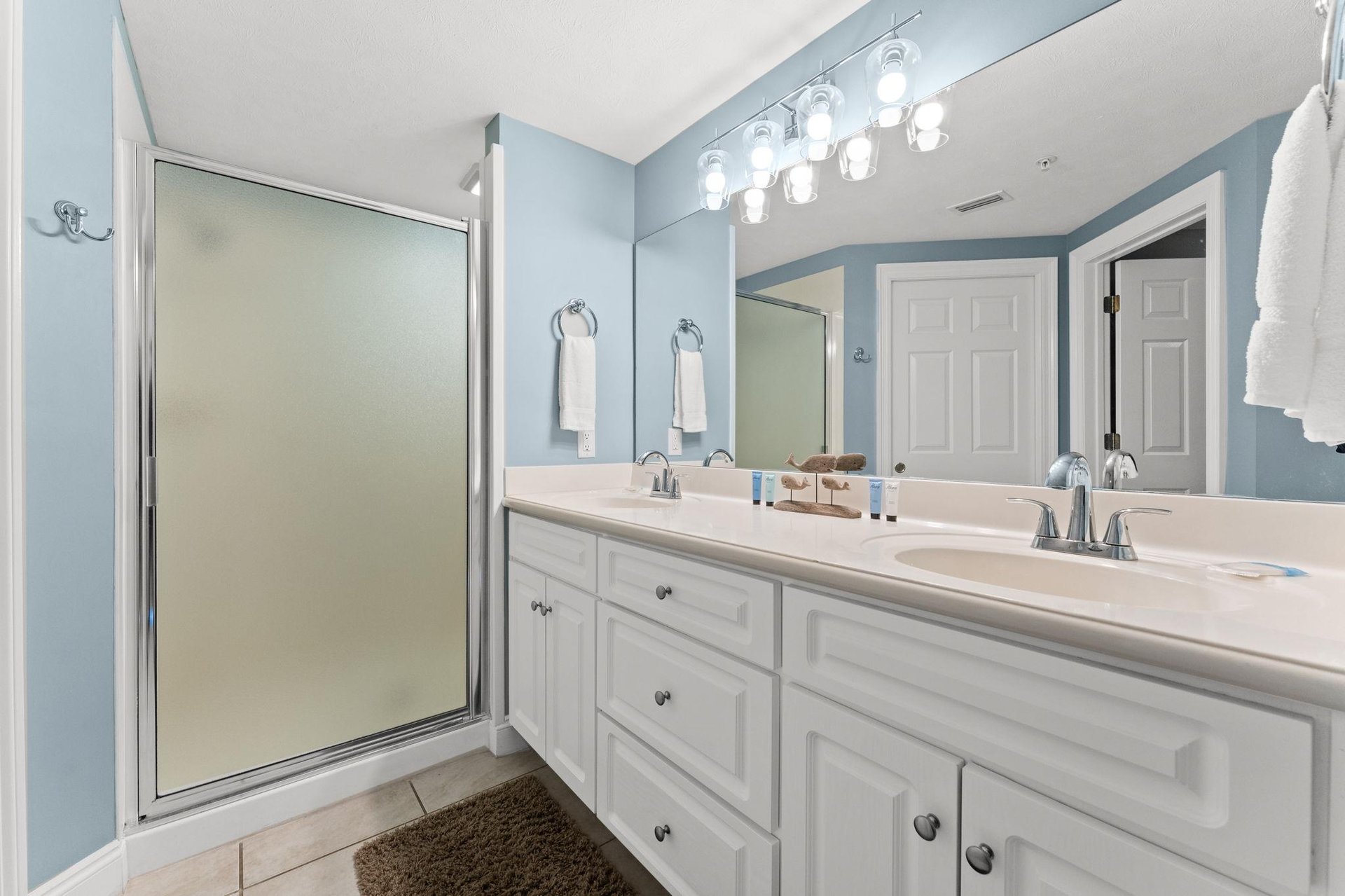 The ensuite master bathroom offers double sinks, a walkin shower, and a separate water closet.