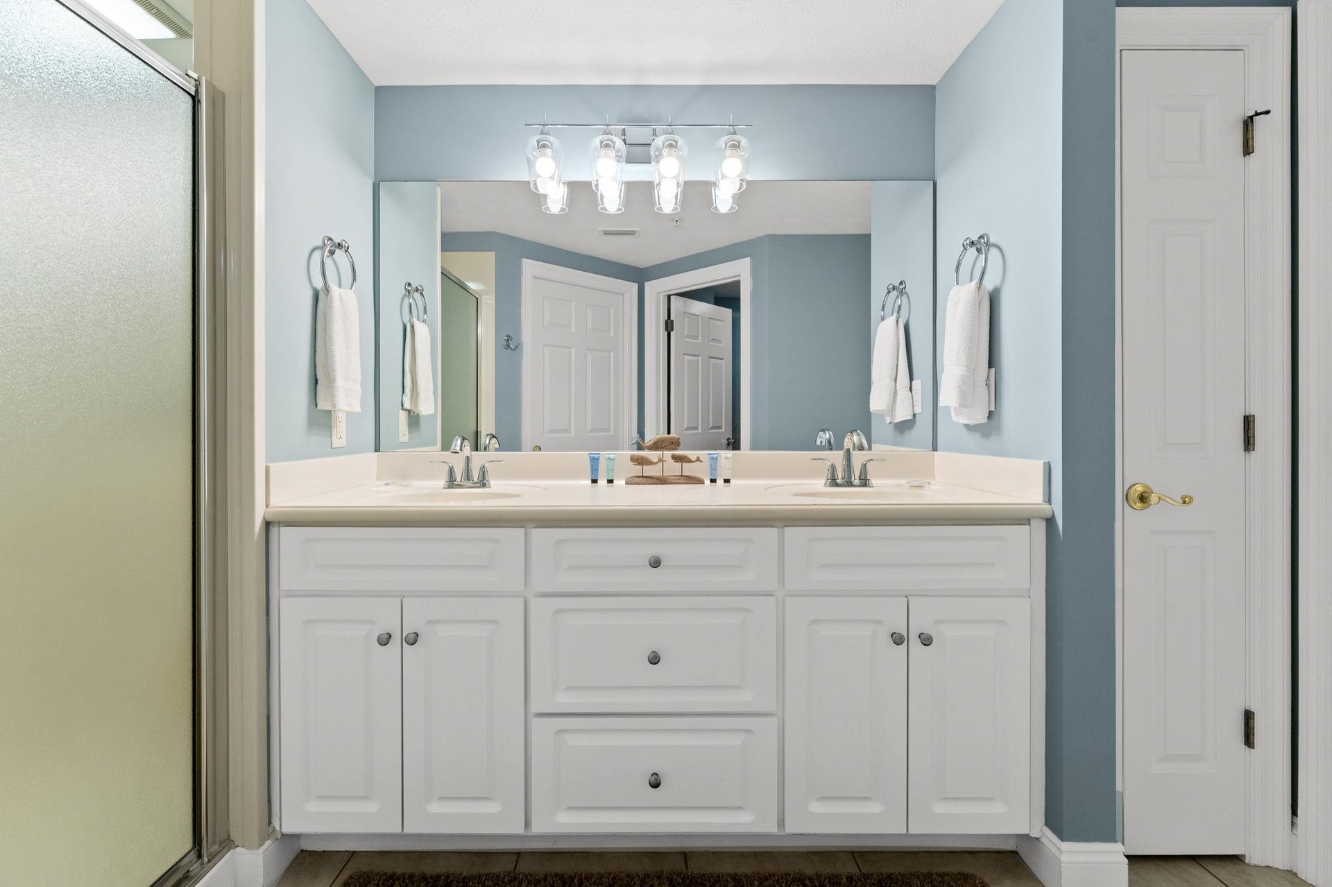 The ensuite master bathroom offers double sinks, a walkin shower, and a separate water closet.