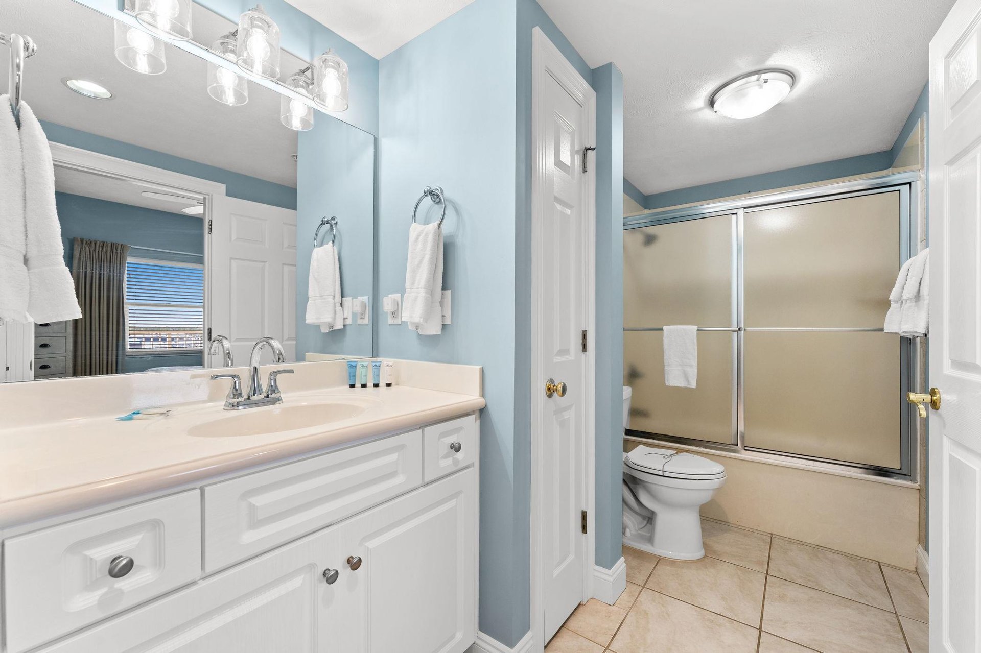The second bathroom, which can be directly accessed from both the front bedroom and the hallway, offers a tubshower combo with glass doors.