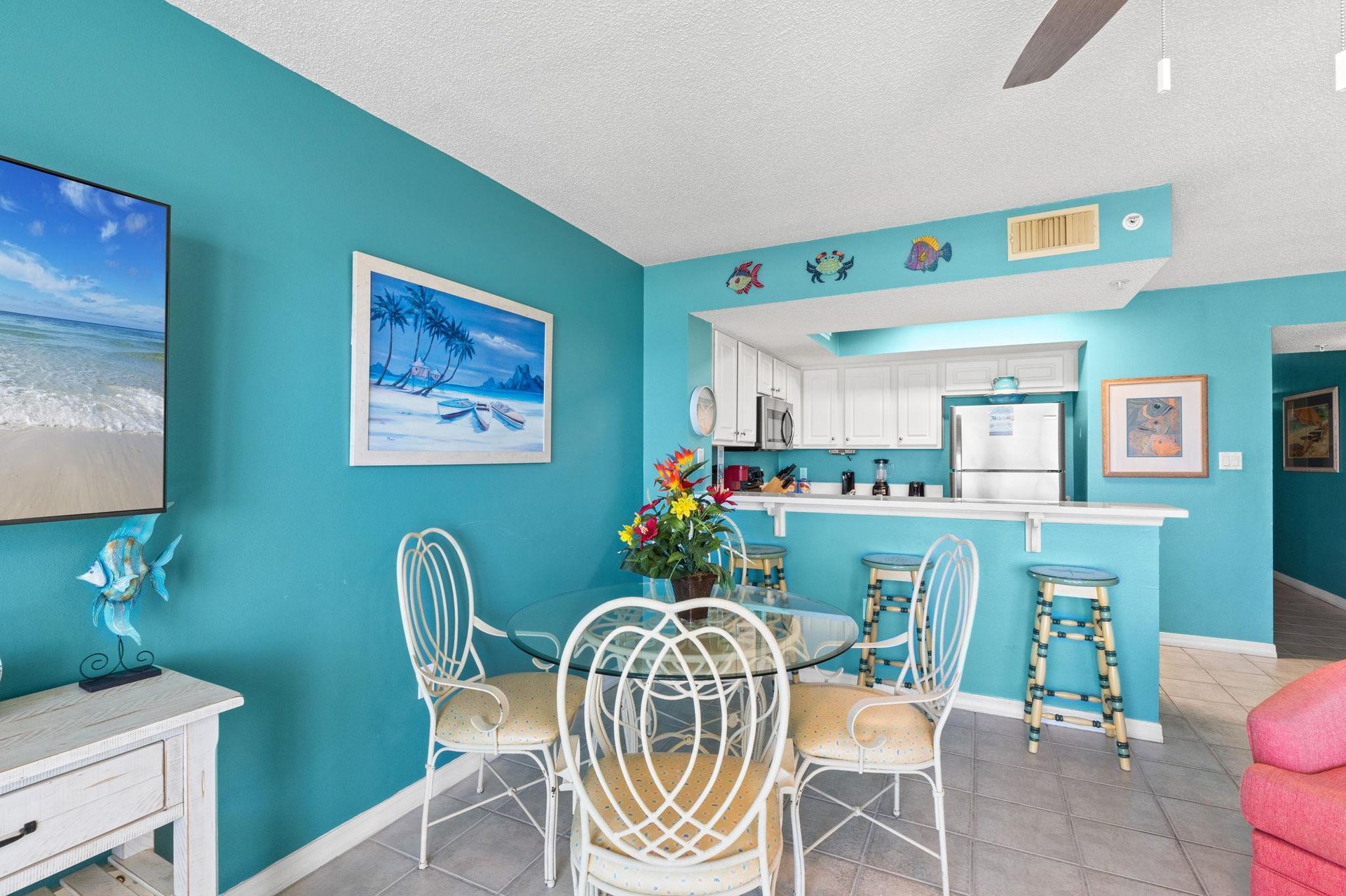 Beachy themed dining area  table that seats 4 plus 3 bar stools