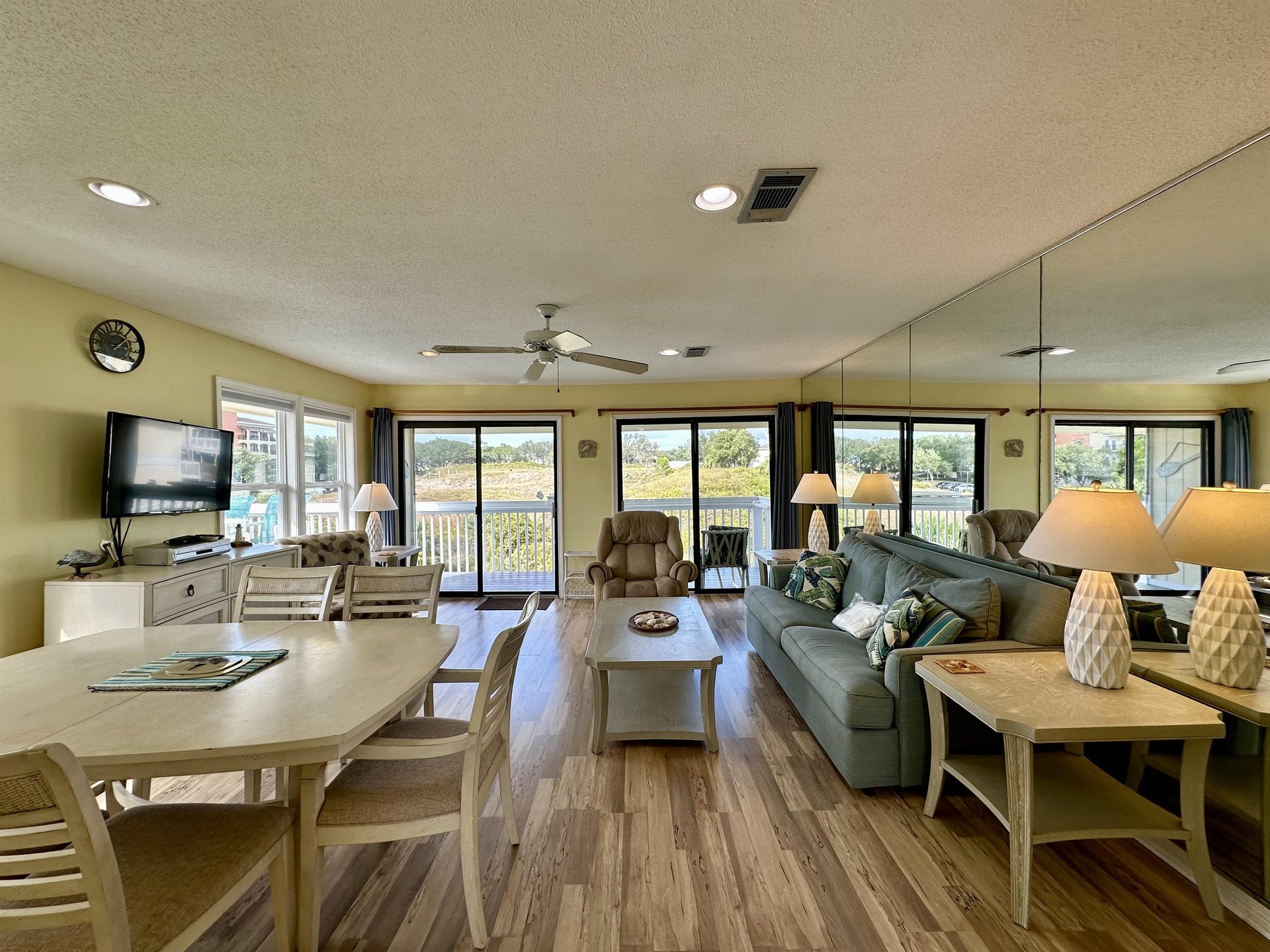 Relax in this bright, open living space with panoramic windows showcasing beautiful marsh views, perfect for peaceful mornings and cozy evenings.