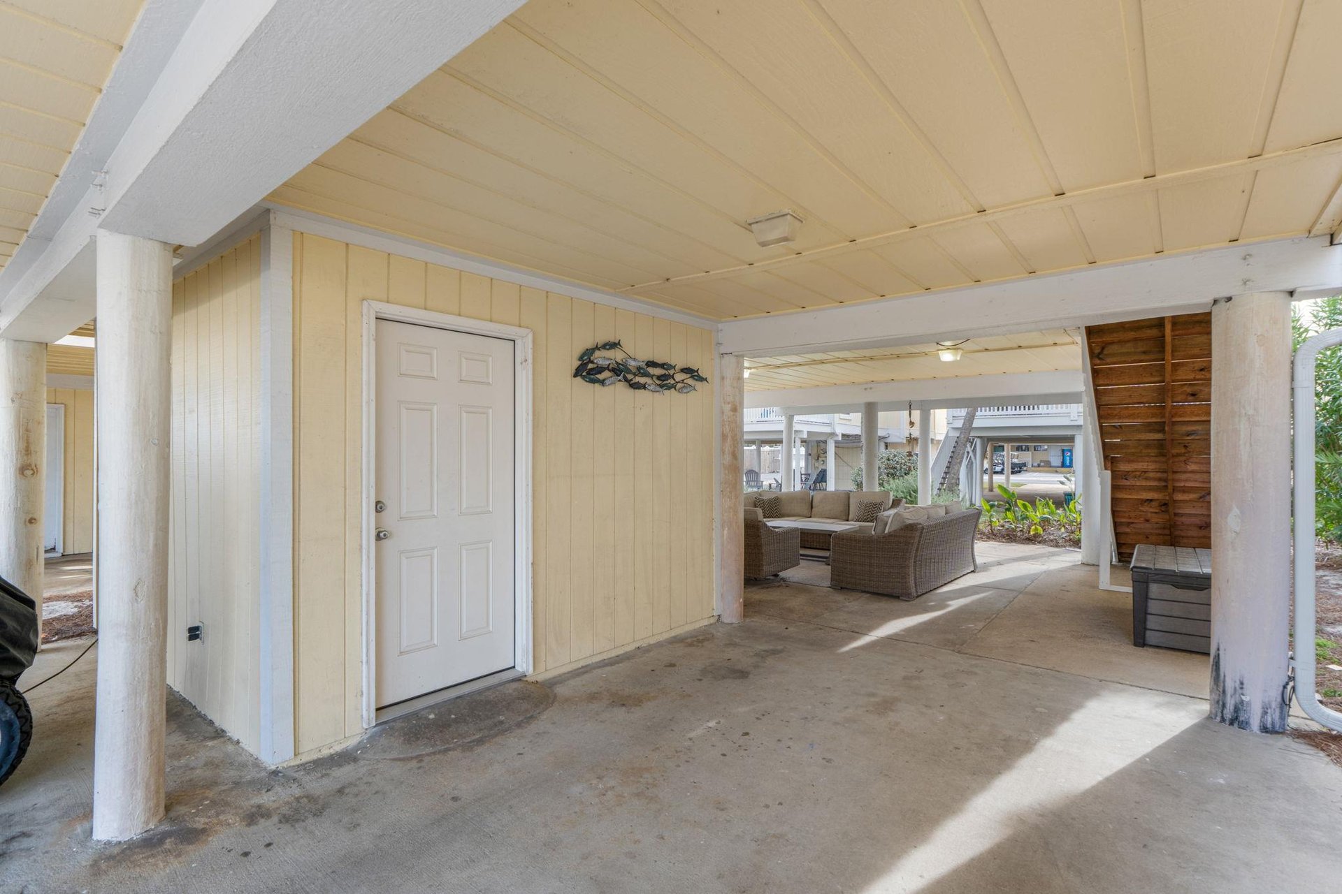 Spacious covered parking area provides convenient shelter for your vehicle while staying at this coastal retreat.
