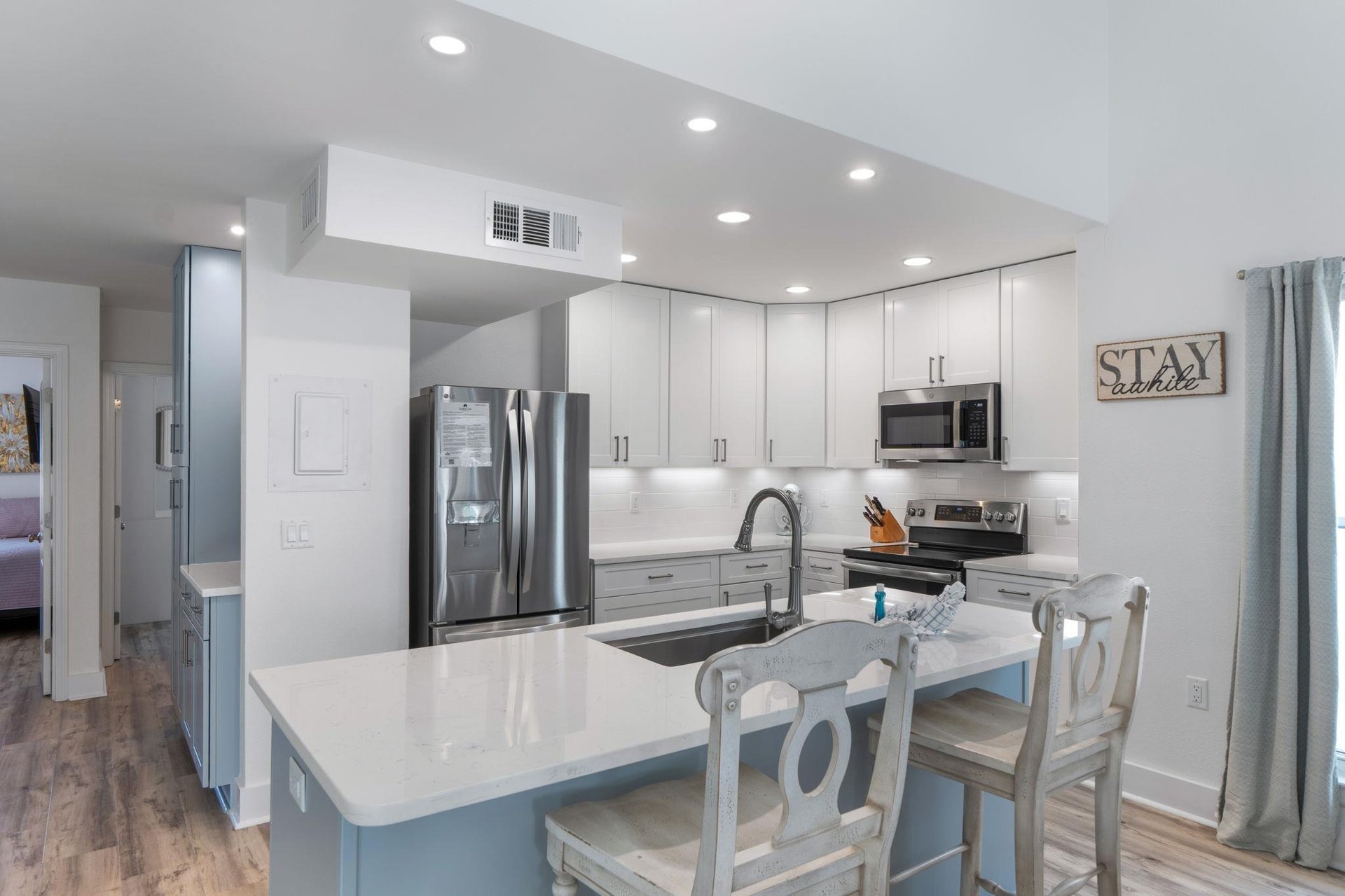 Your fullyequipped modern kitchen features granite countertops, stainless steel appliances, and breakfast bar seating for memorable family meals together.