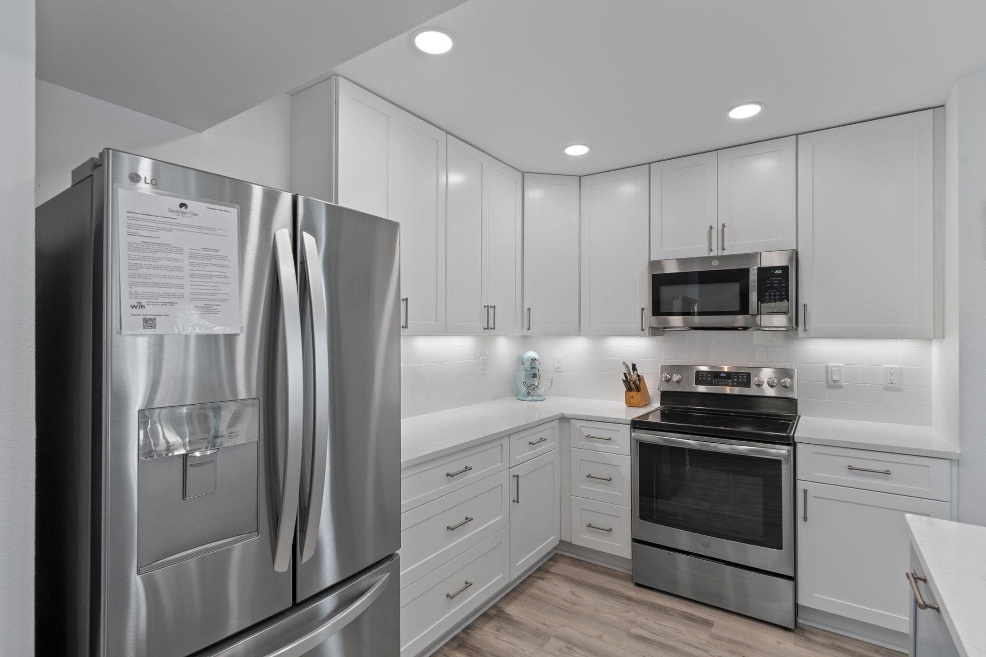 Your sleek modern kitchen features stainless steel appliances, crisp white cabinets, and warm undercabinet lighting for effortless meal preparation.