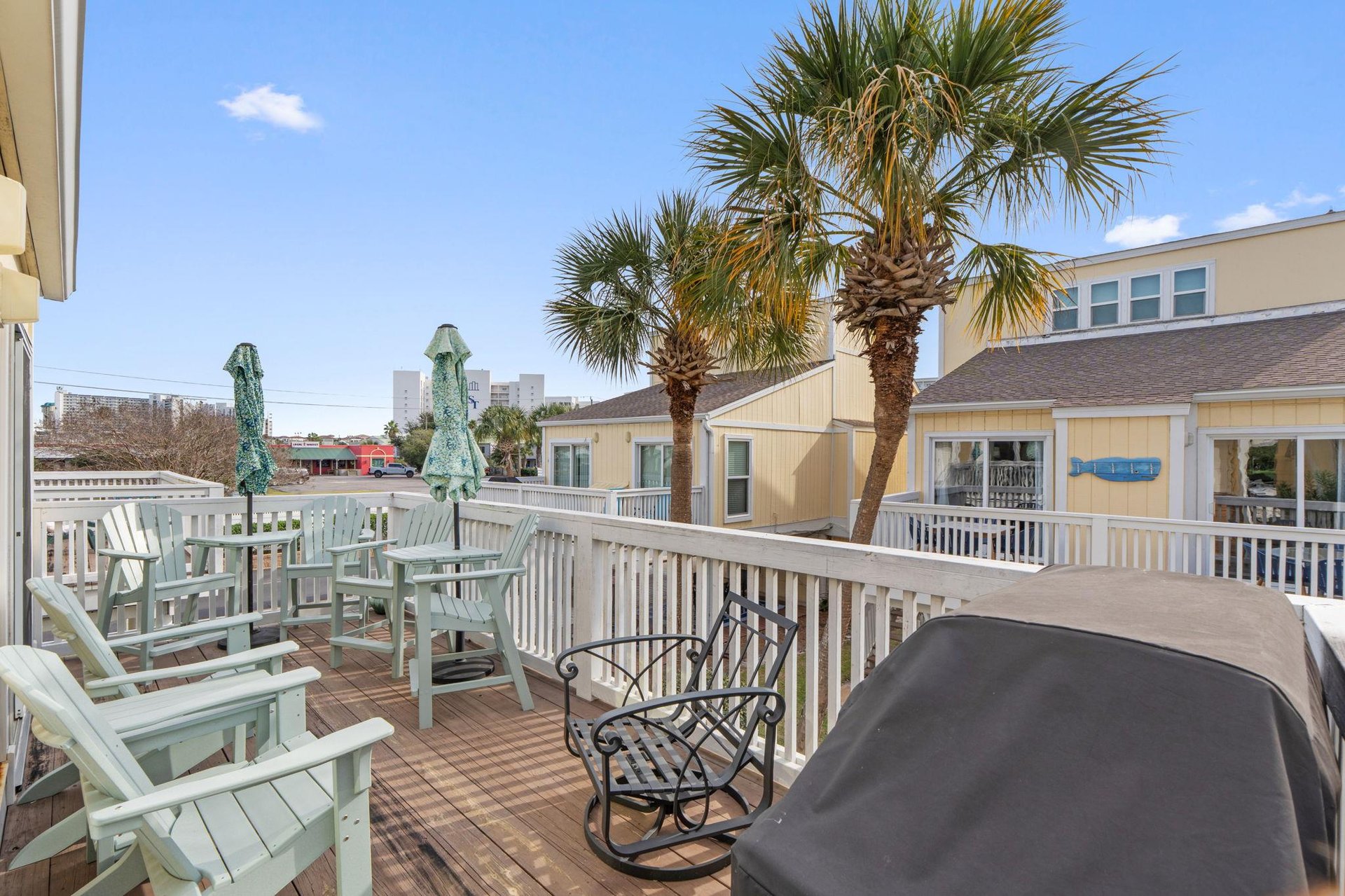 Your spacious deck overlooks swaying palms and coastal charm, perfect for morning coffee or sunset cocktails in paradise.