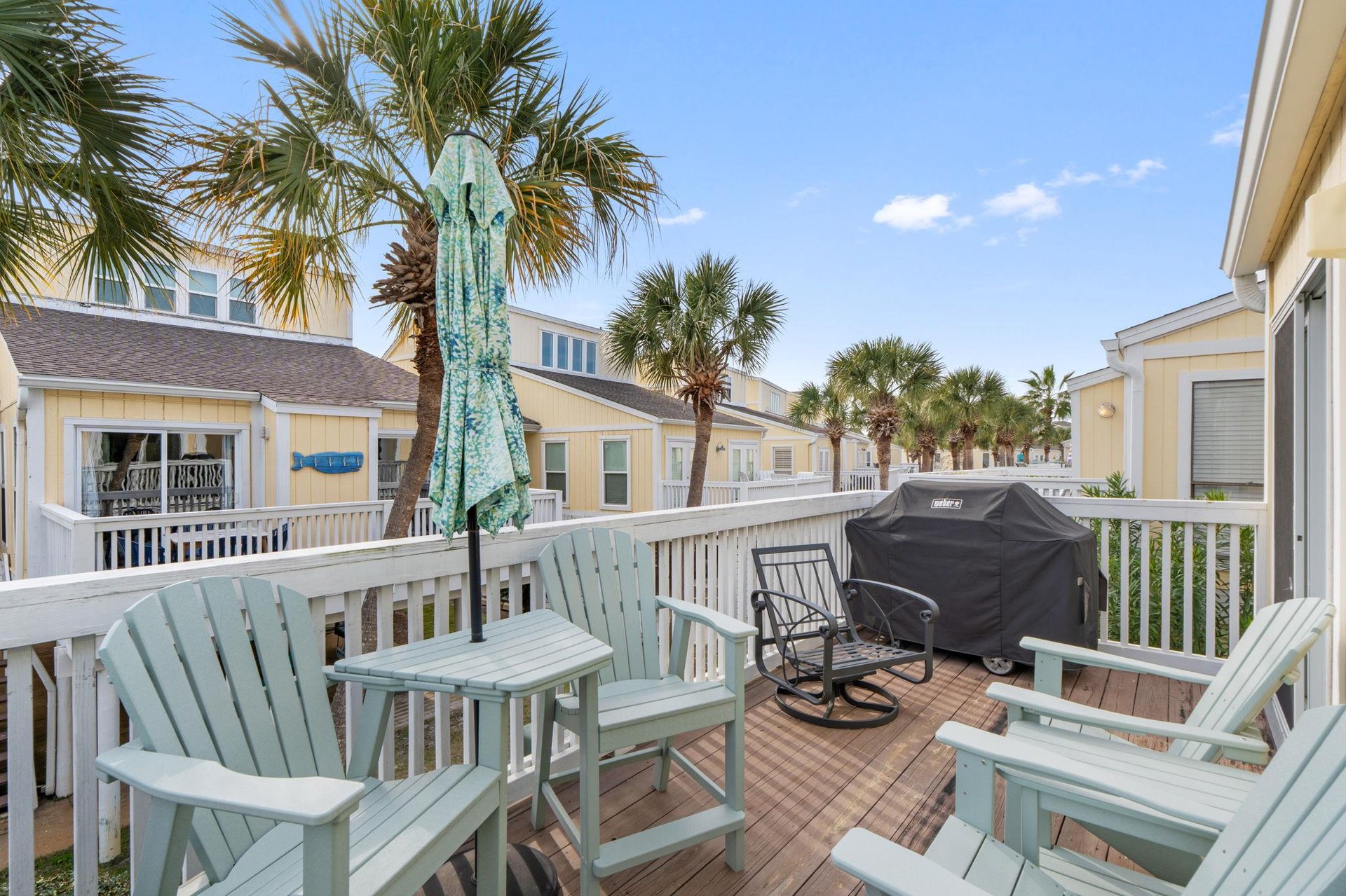 Unwind on your private deck with coastalstyle seating and BBQ, surrounded by swaying palms under endless blue skies.