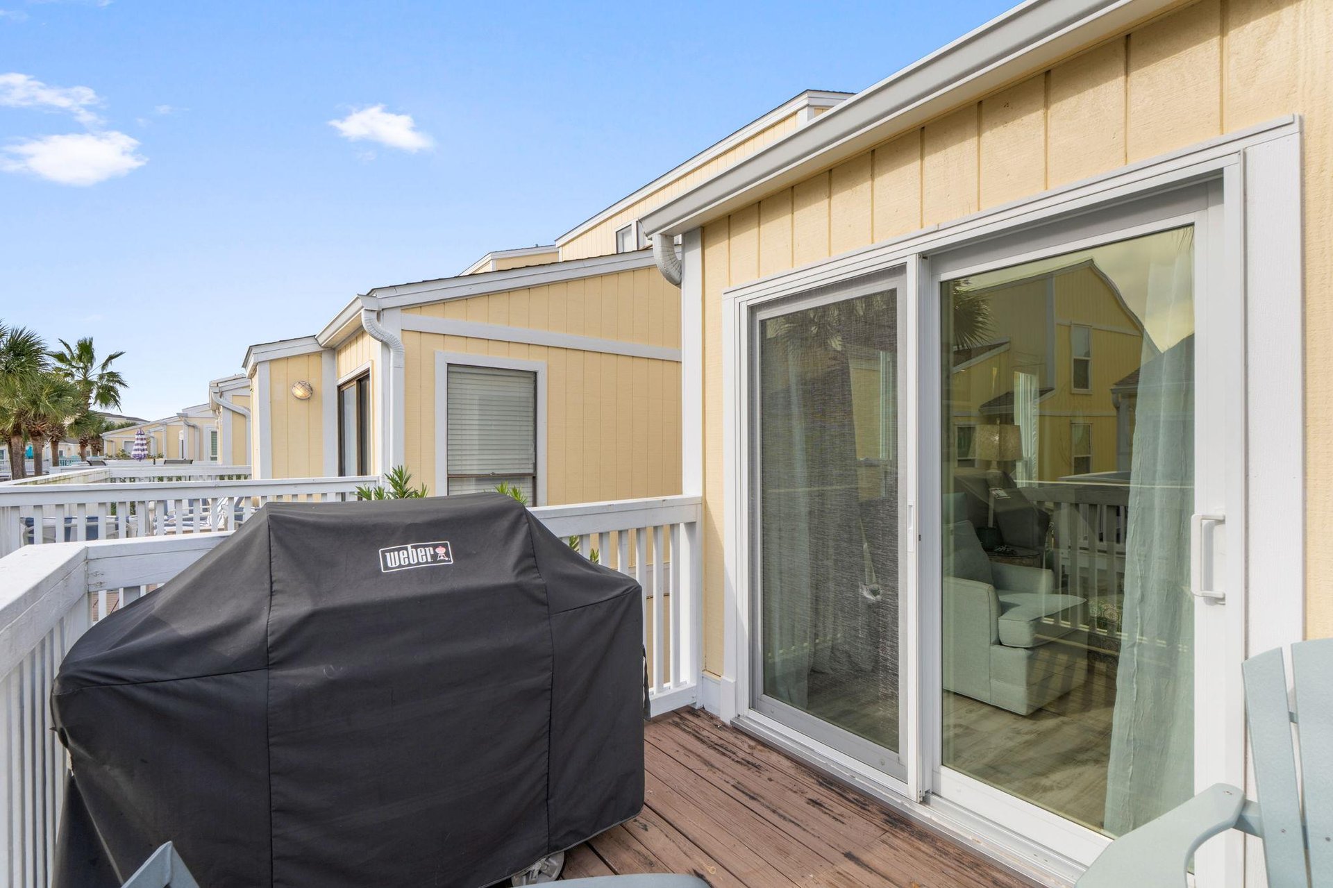 Your private terrace features a Weber grill for beachside barbecues, with glass doors opening to your comfortable living space.