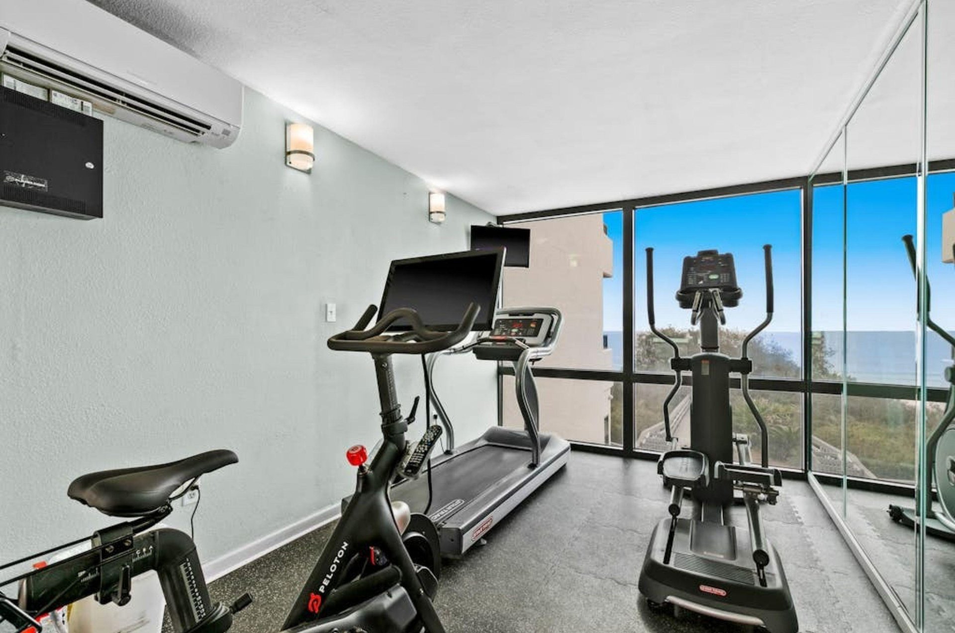 The gym with cardio equipment at One Seagrove Place on Highway 30A in Florida