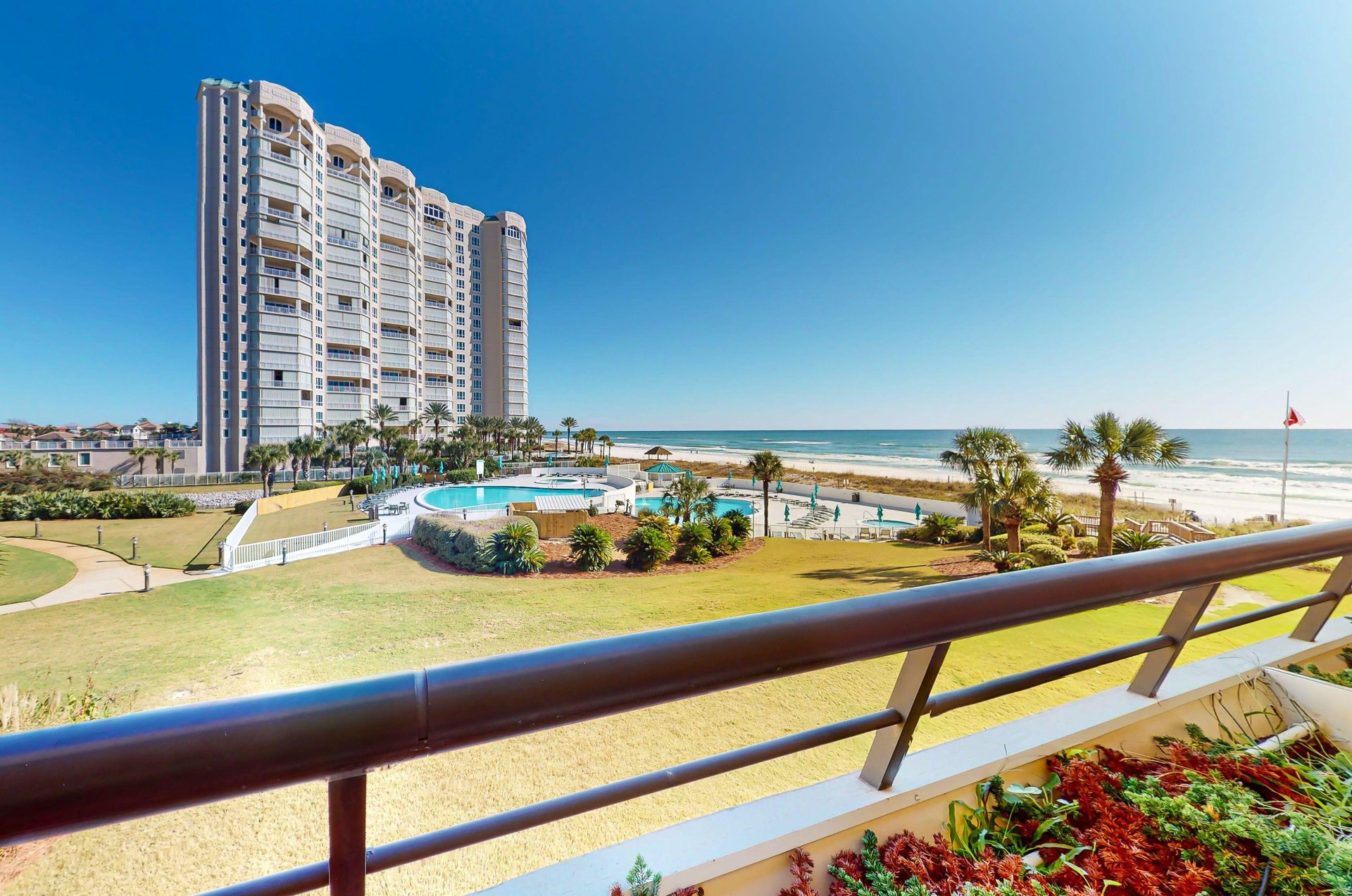 Edgewaters balconies provide sweeping views of the beach, pools, and hot tub.