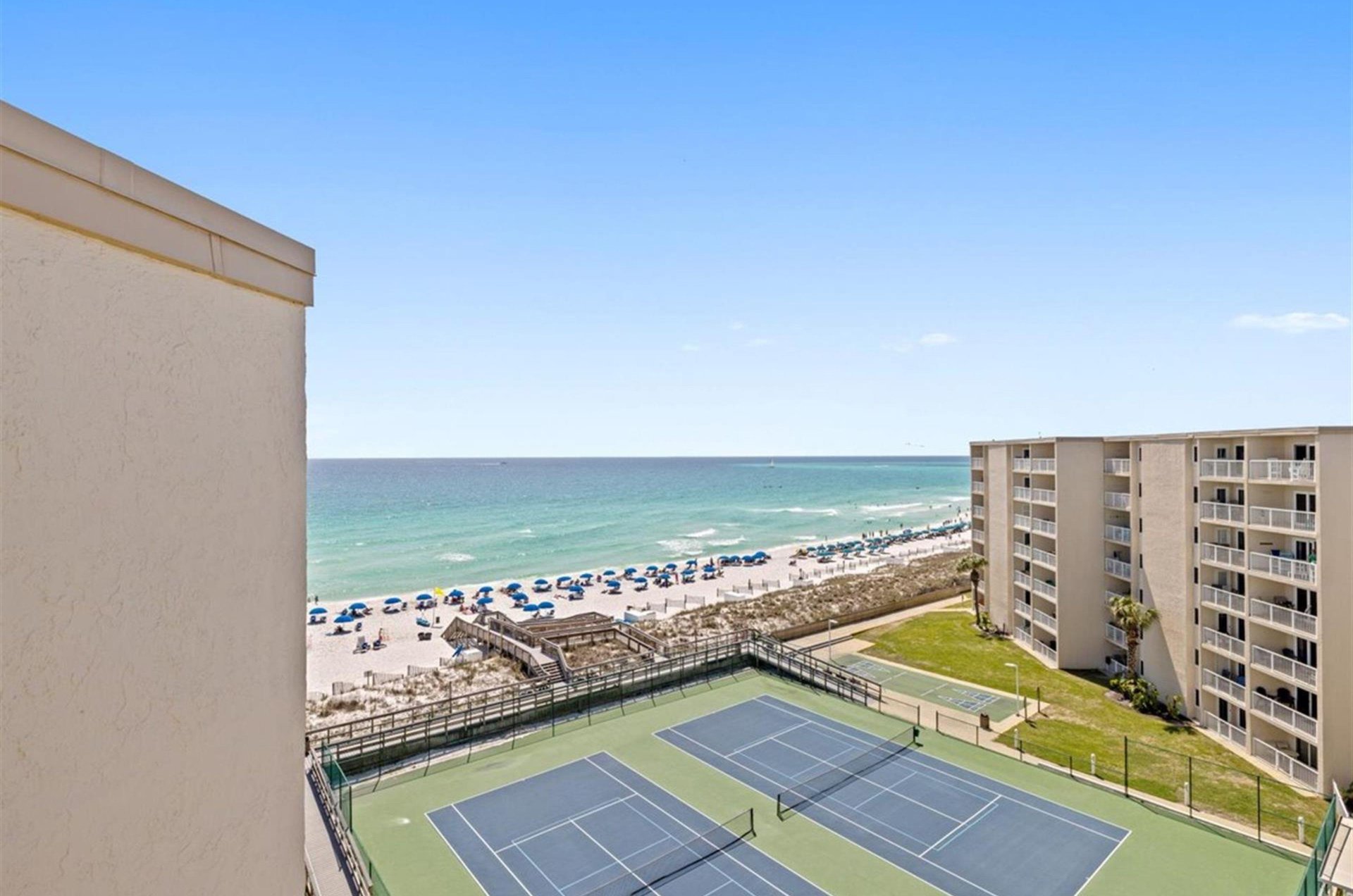 A view from the complex of the tennis courts and boardwalk leading to the beautiful beach.