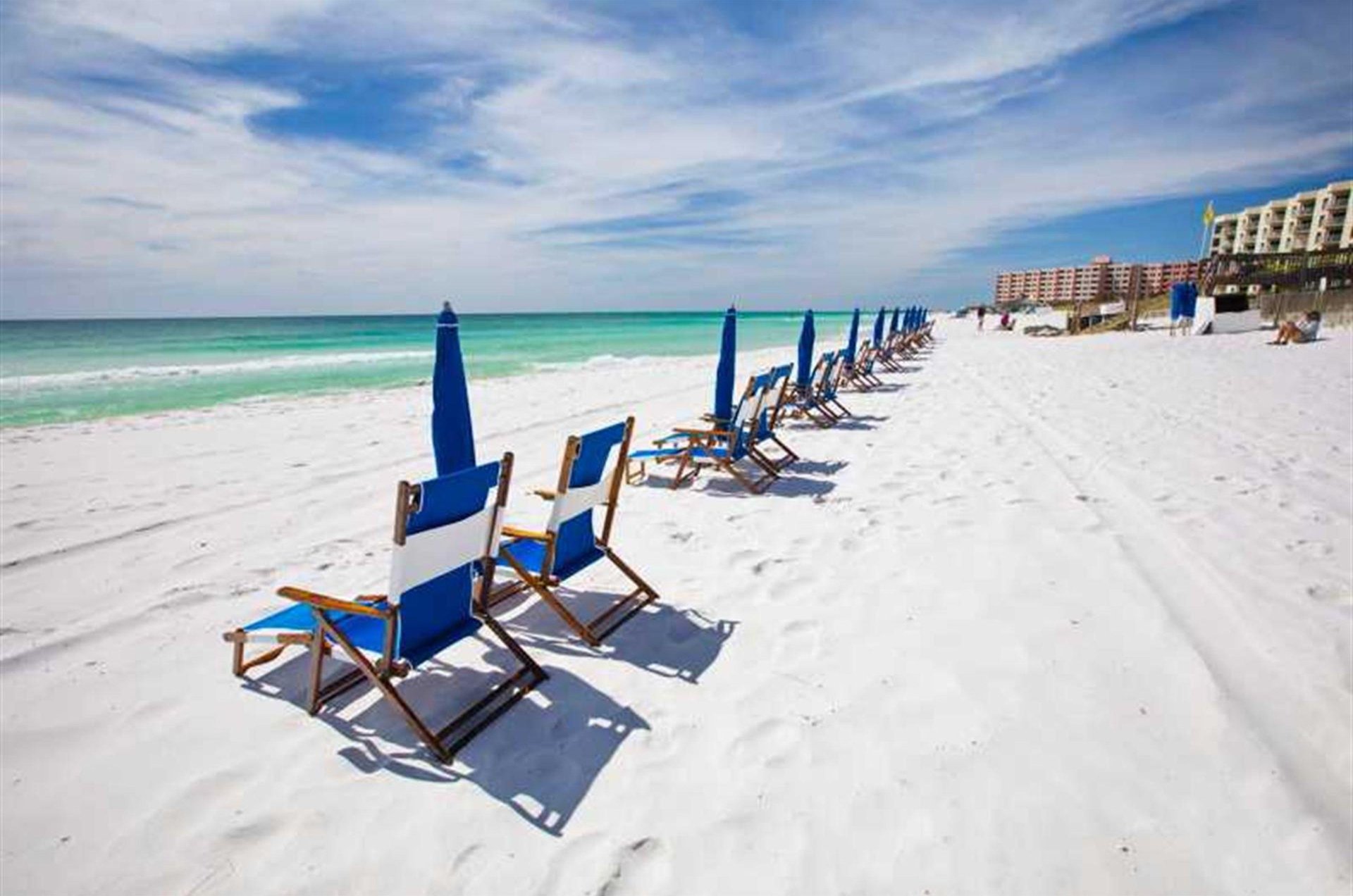 Beach chairs and umbrellas ready to provide frontrow views of the Gulf.
