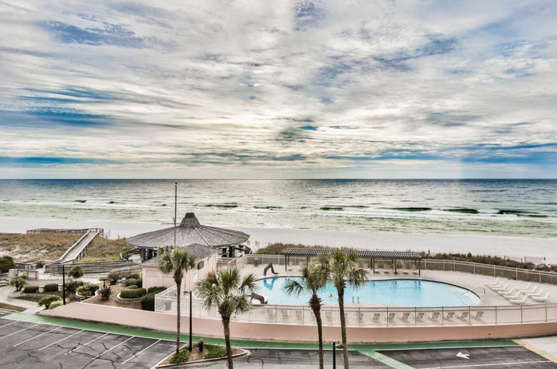 View of the pool, picnic pavillion, boardwalk, and coastline