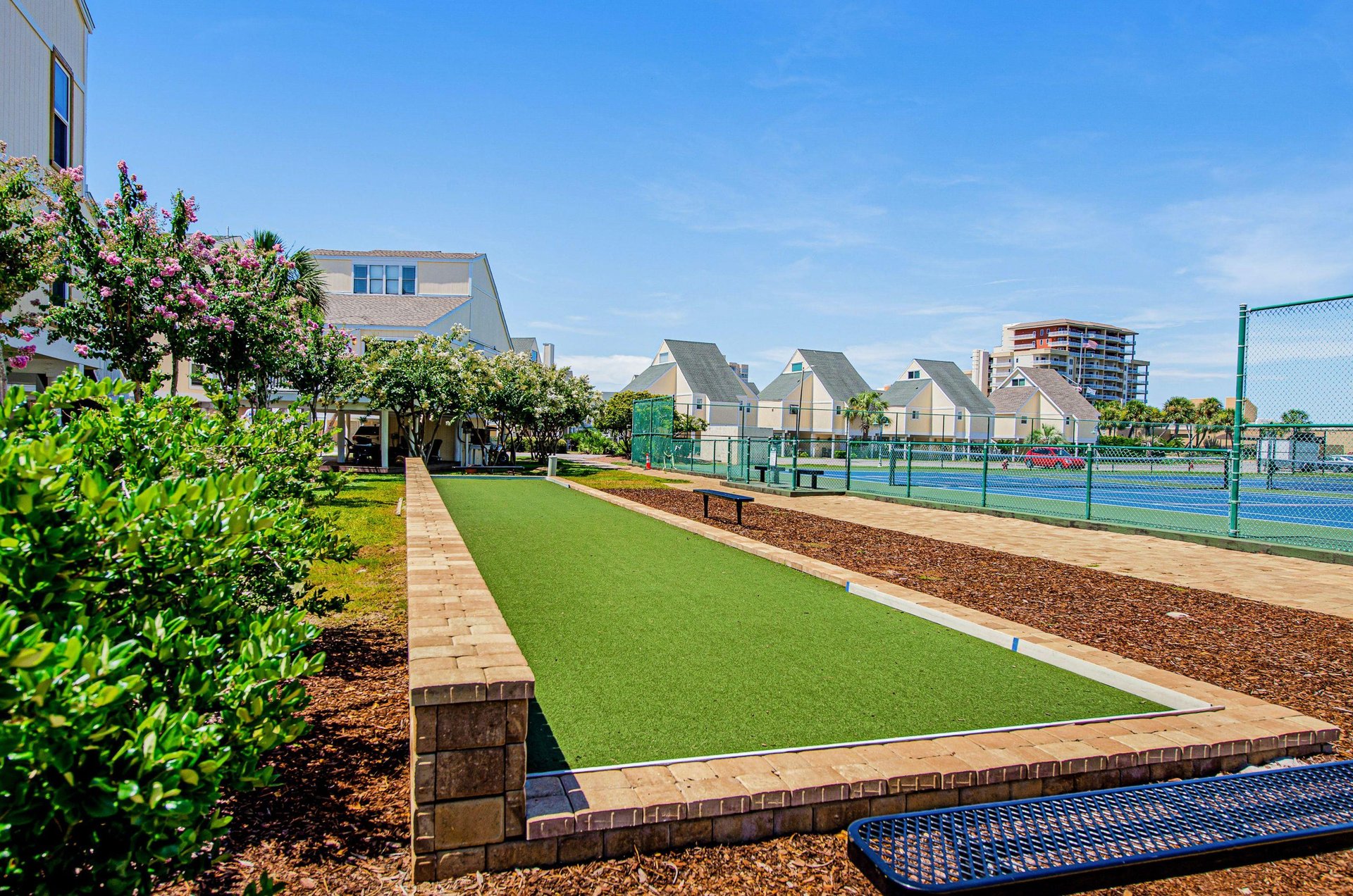 A Sandpiper Cove putting green and tennis courts