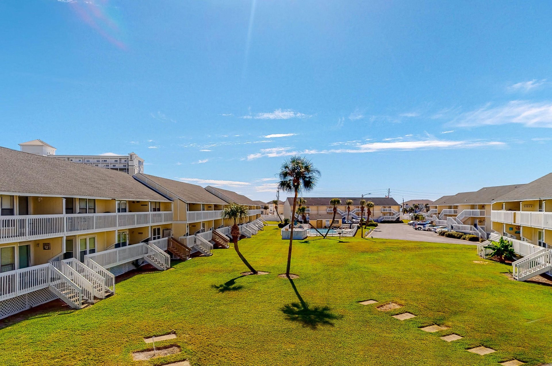 Balconies looking out over the lawn and swimming pool