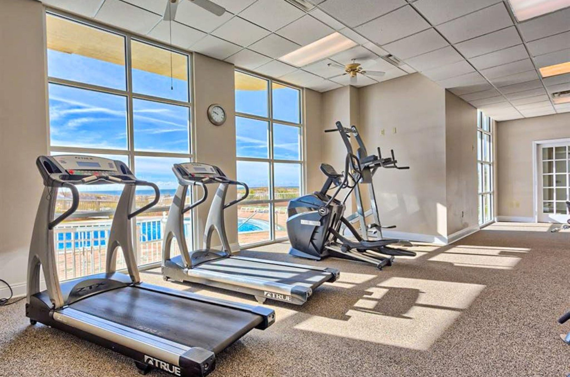 The wellequipped fitness center with strength and cardio equipment overlooking the Gulf