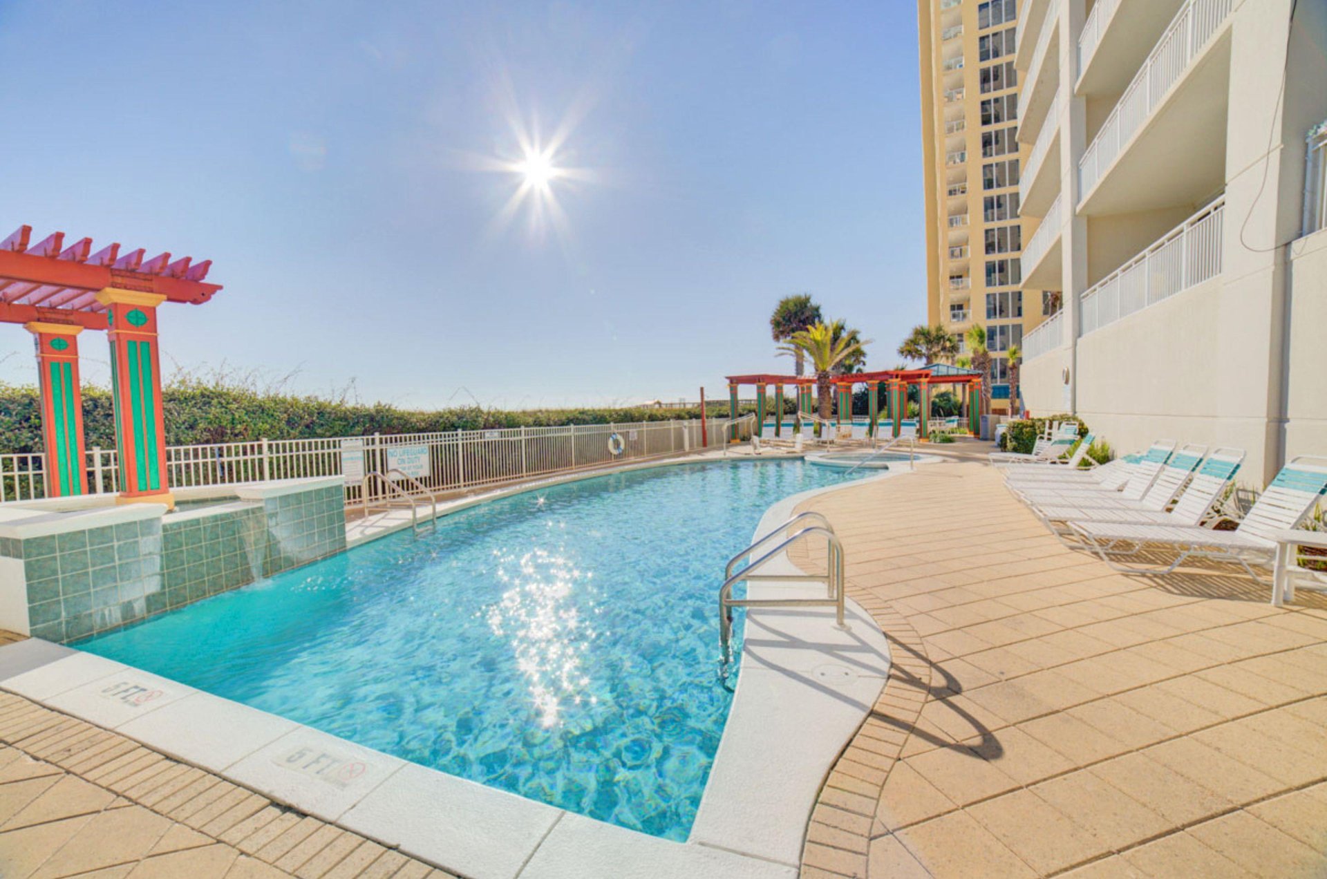 The beachfront outdoor swimming pool next to the resort
