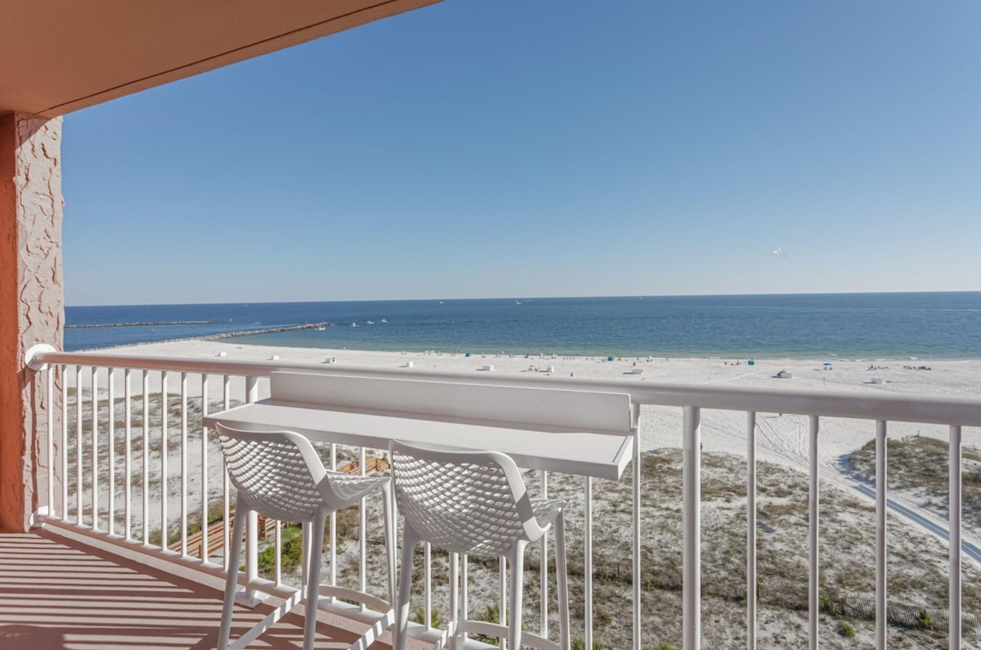 A private balcony with a chair overlooking the Gulf in Orange Beach Alabama