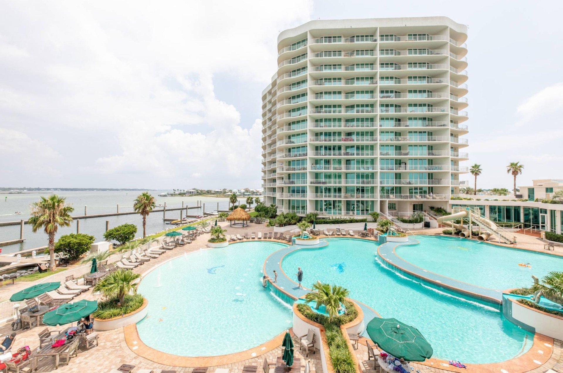 The large outdoor swimming pool in front of one of the buildings at Caribe Resort in Orange Beach Alabama