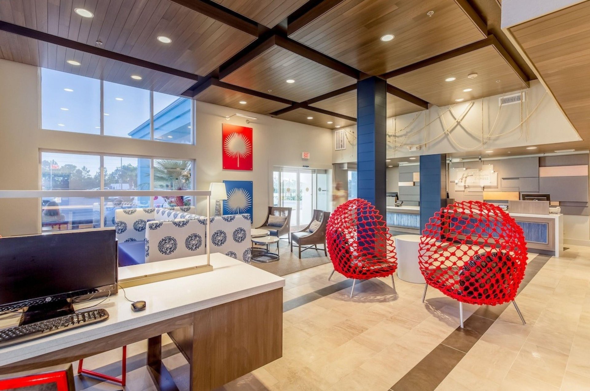 The lobby with chairs and a computer at Holiday Inn Express in Orange Beach Alabama