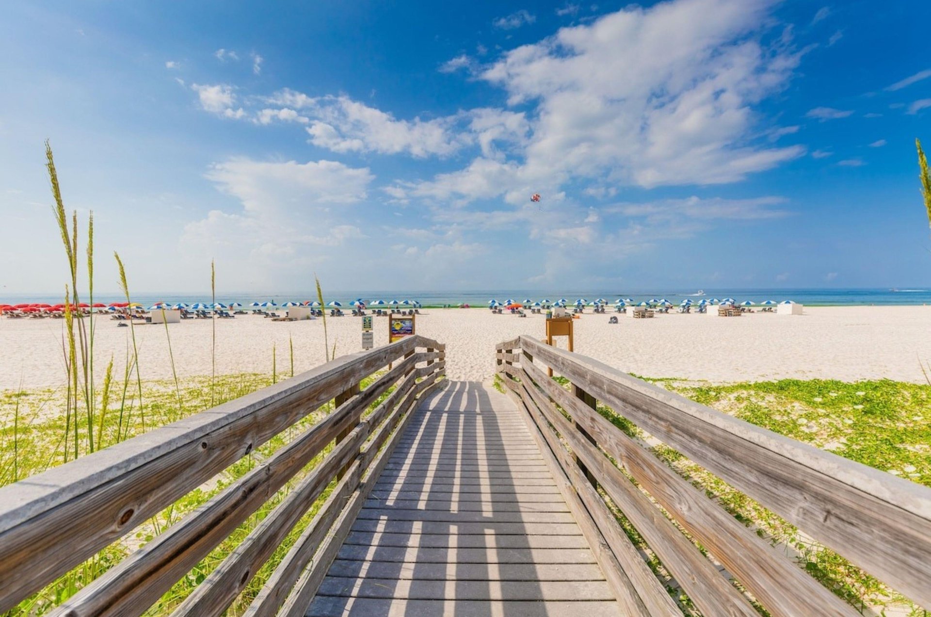 A wooden boardwalk leading to the beach at Holiday Inn Express