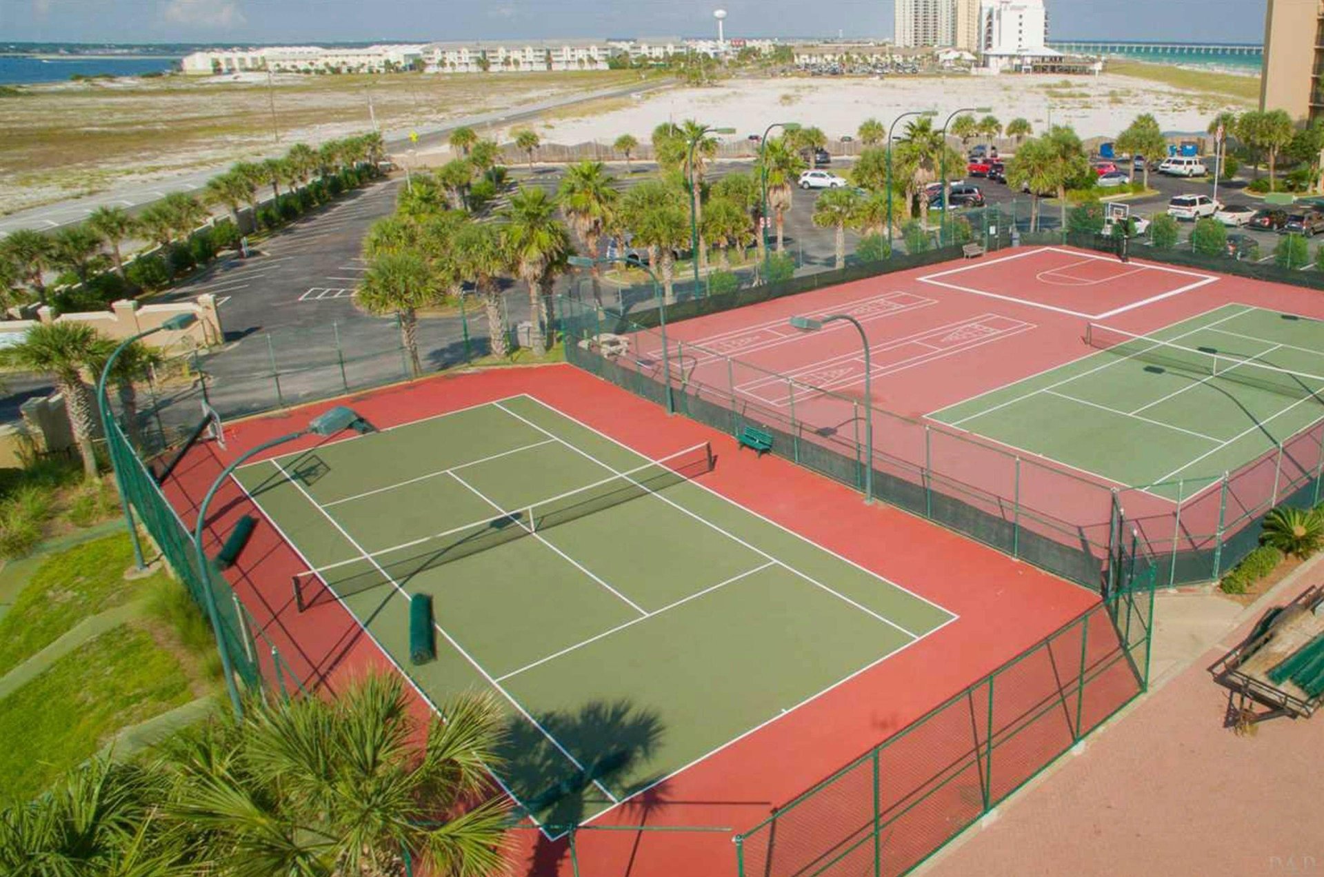Aerial view of outdoor basketball and tennis courts at Belle Mer Condominiums