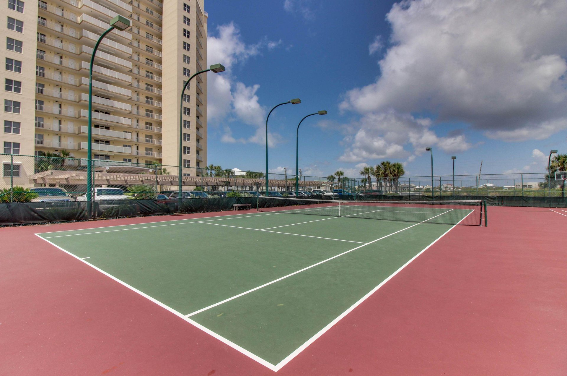 Outdoor basketball courts next to the exterior of Navarre Towers