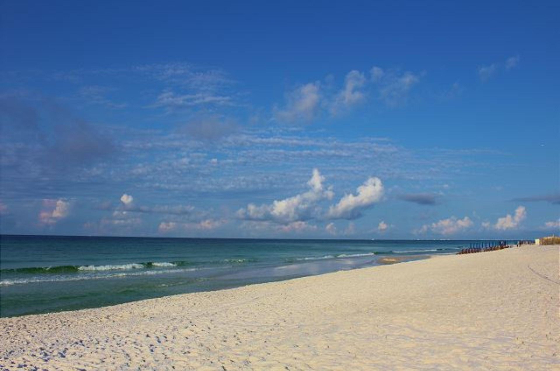 Southbay by the Gulfs beach under fluffy white clouds