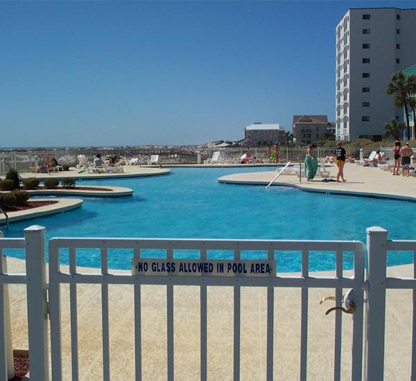 View through the fence to the swimming pool at Gulf Shores Plantation
