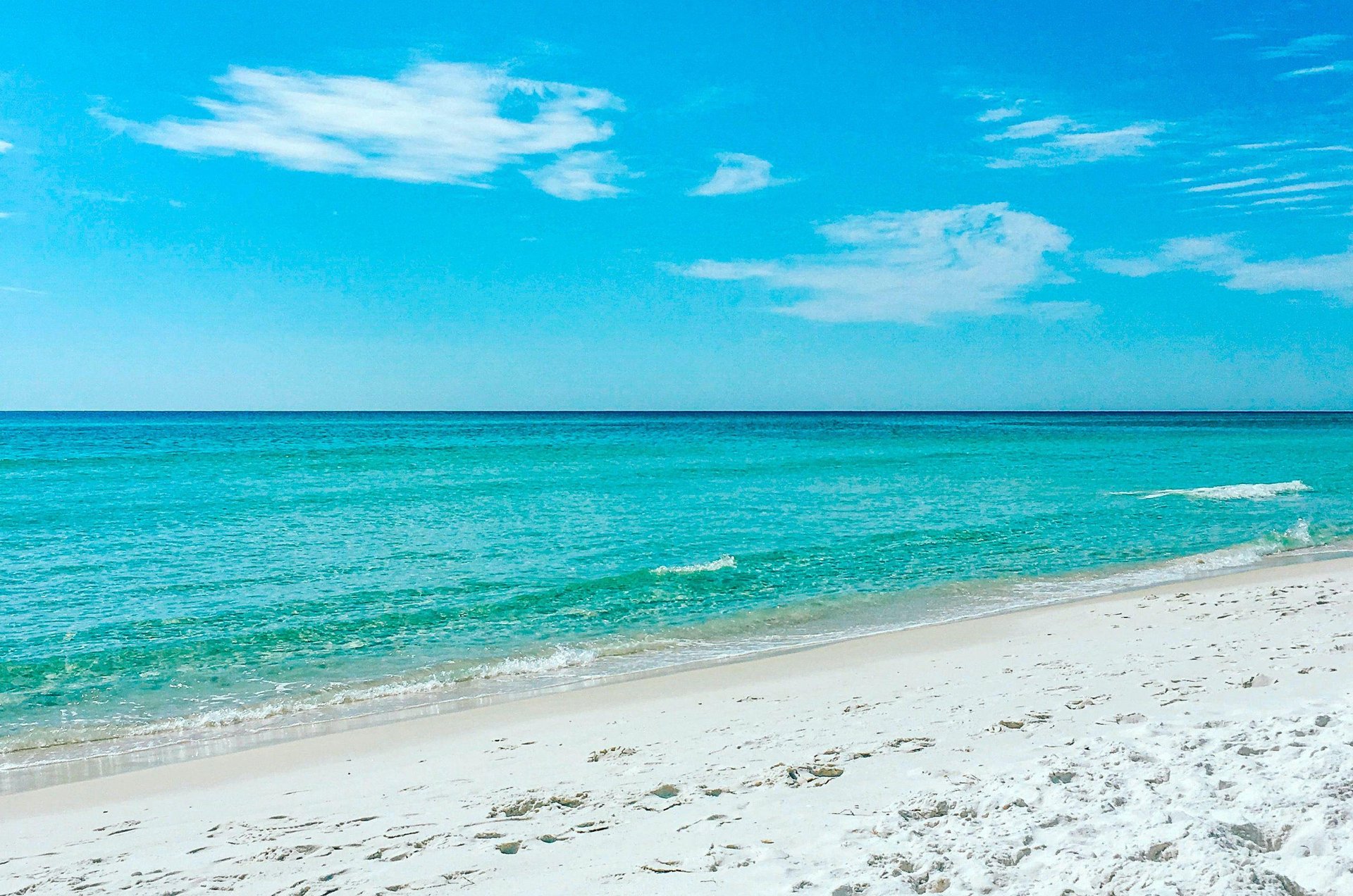 Mainsails sparkling shoreline