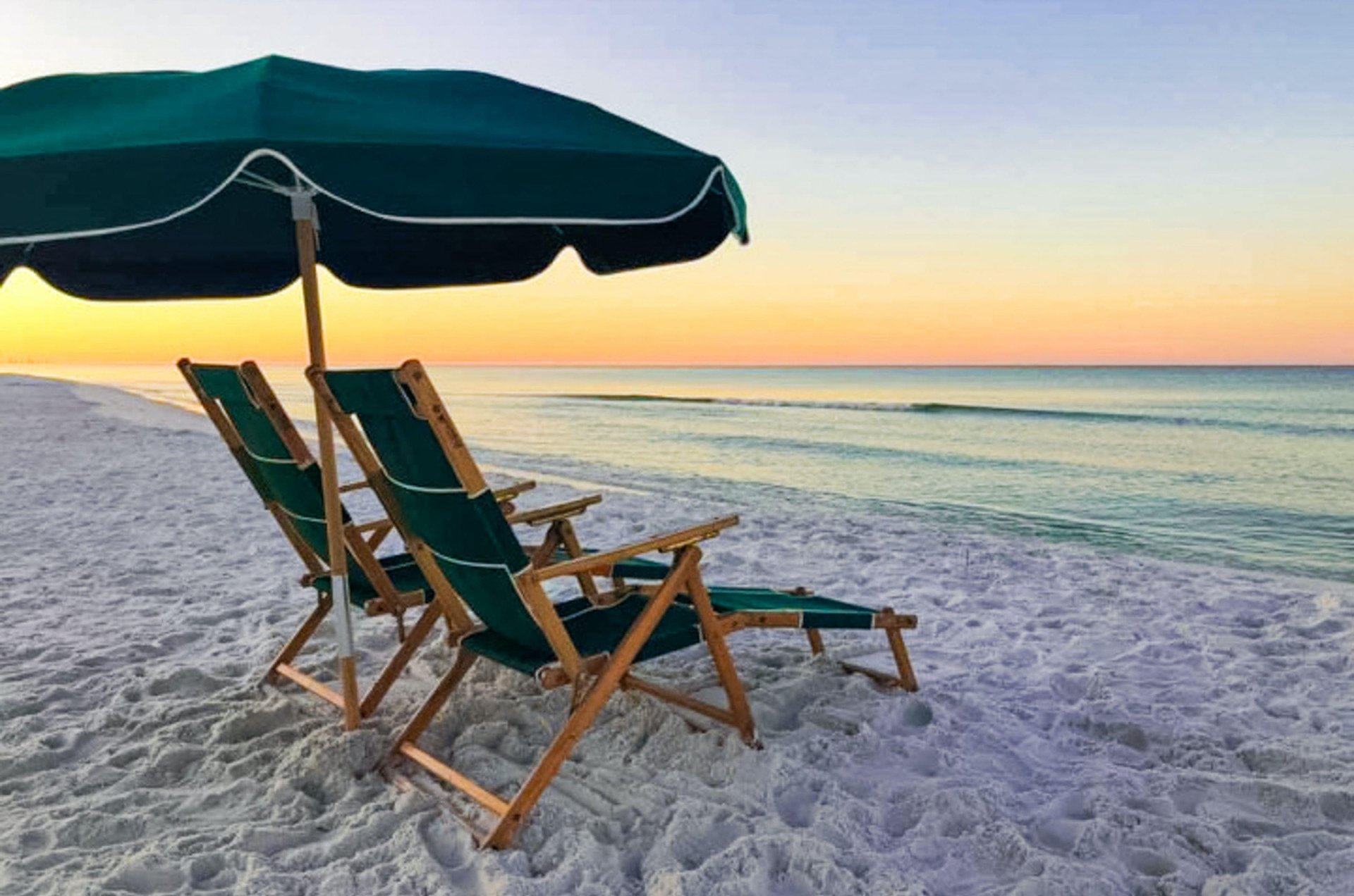 Beach chairs and umbrella on the coast by the property