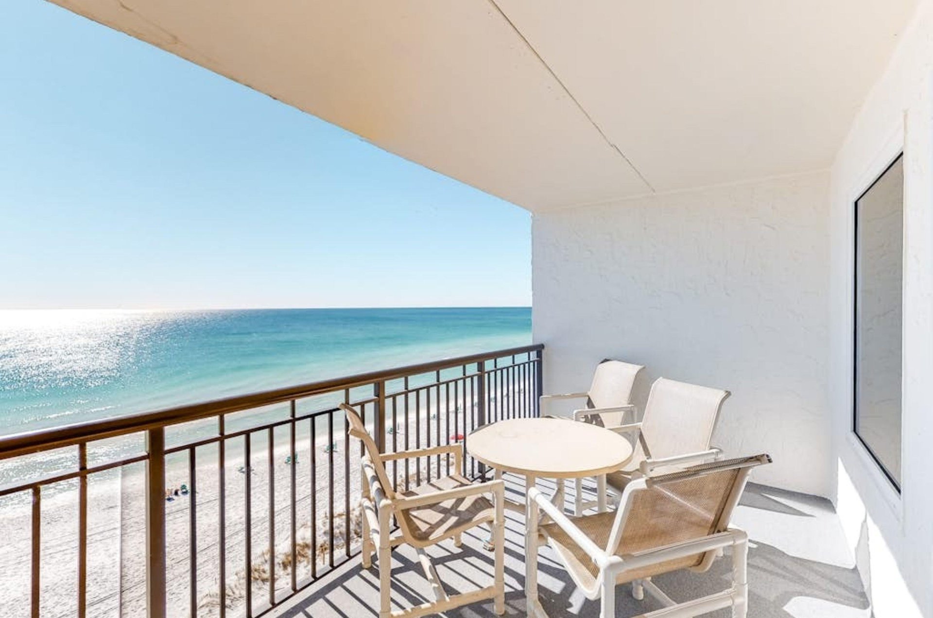A private balcony with a table and chairs overlooking the Gulf at Island Echos