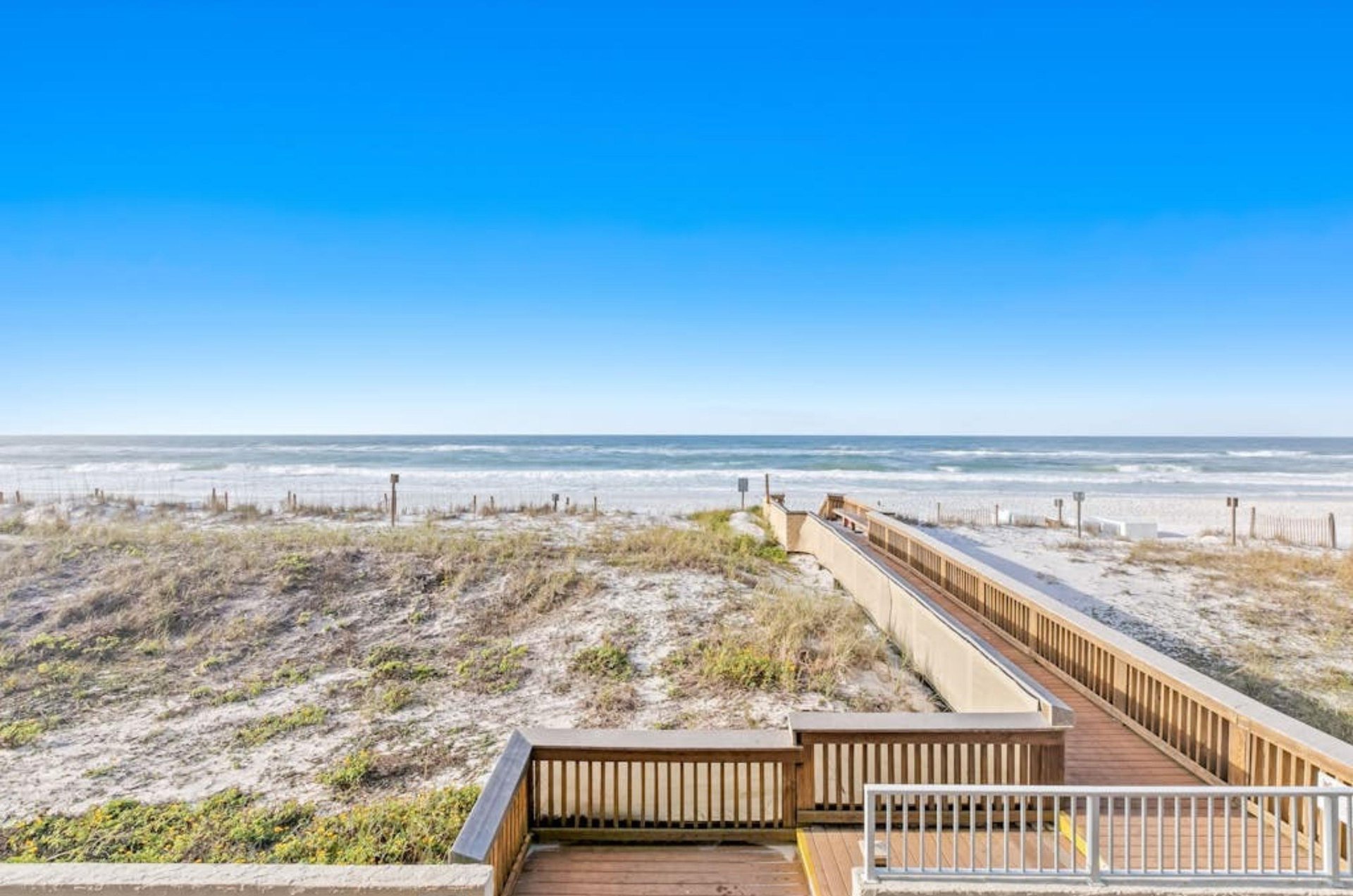 A wooden boardwalk leading to the Gulf in front of Island Echos Condos in Fort Walton Beach Florida