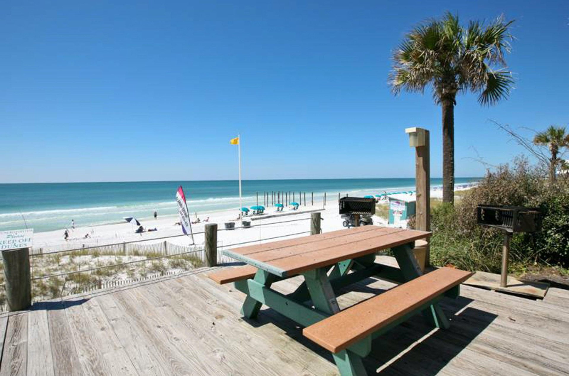 A community picnic table overlooking the private beach.