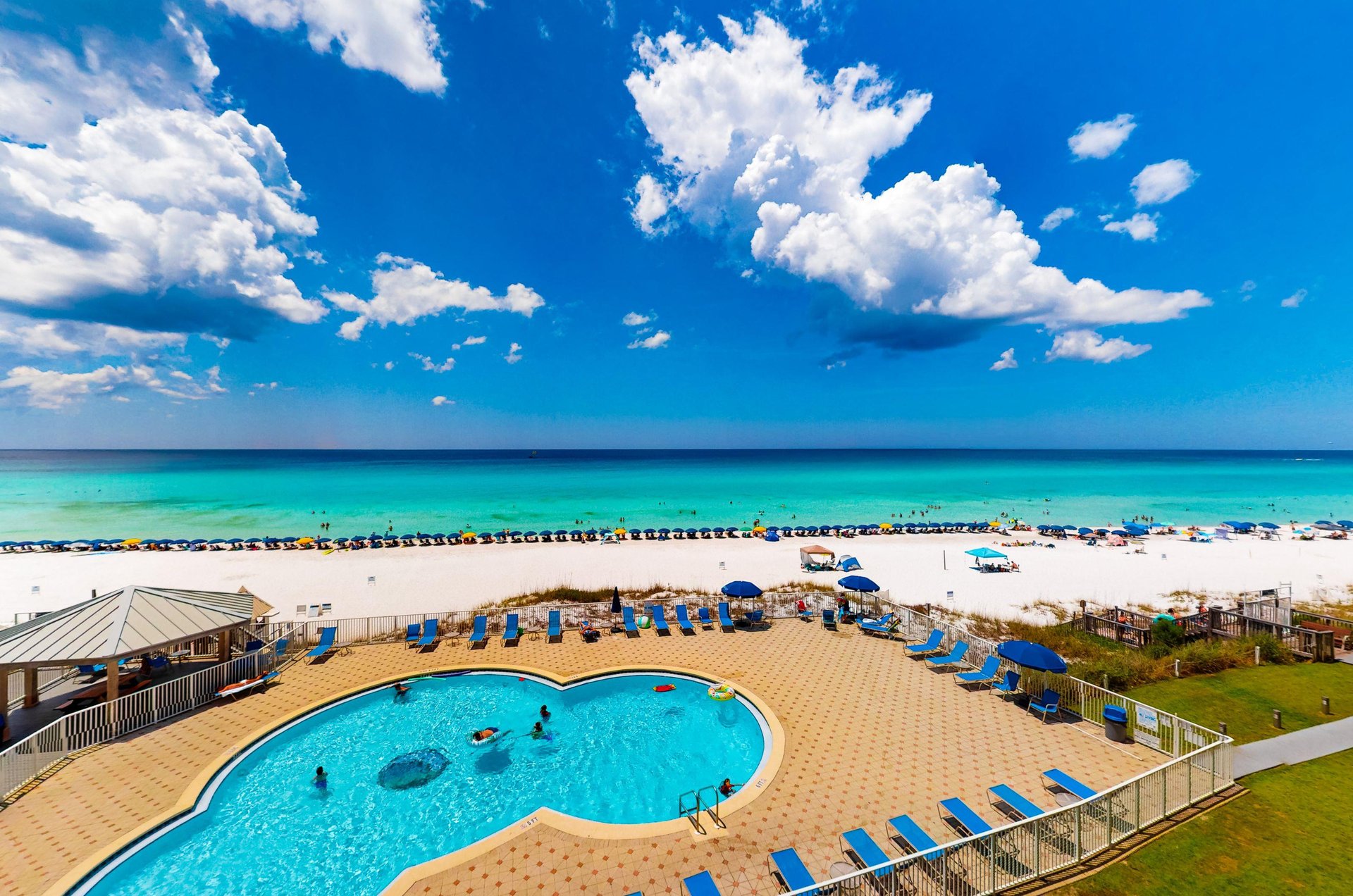 Beach House condos provide panoramic views of the Gulf and the sparkling swimming pool.