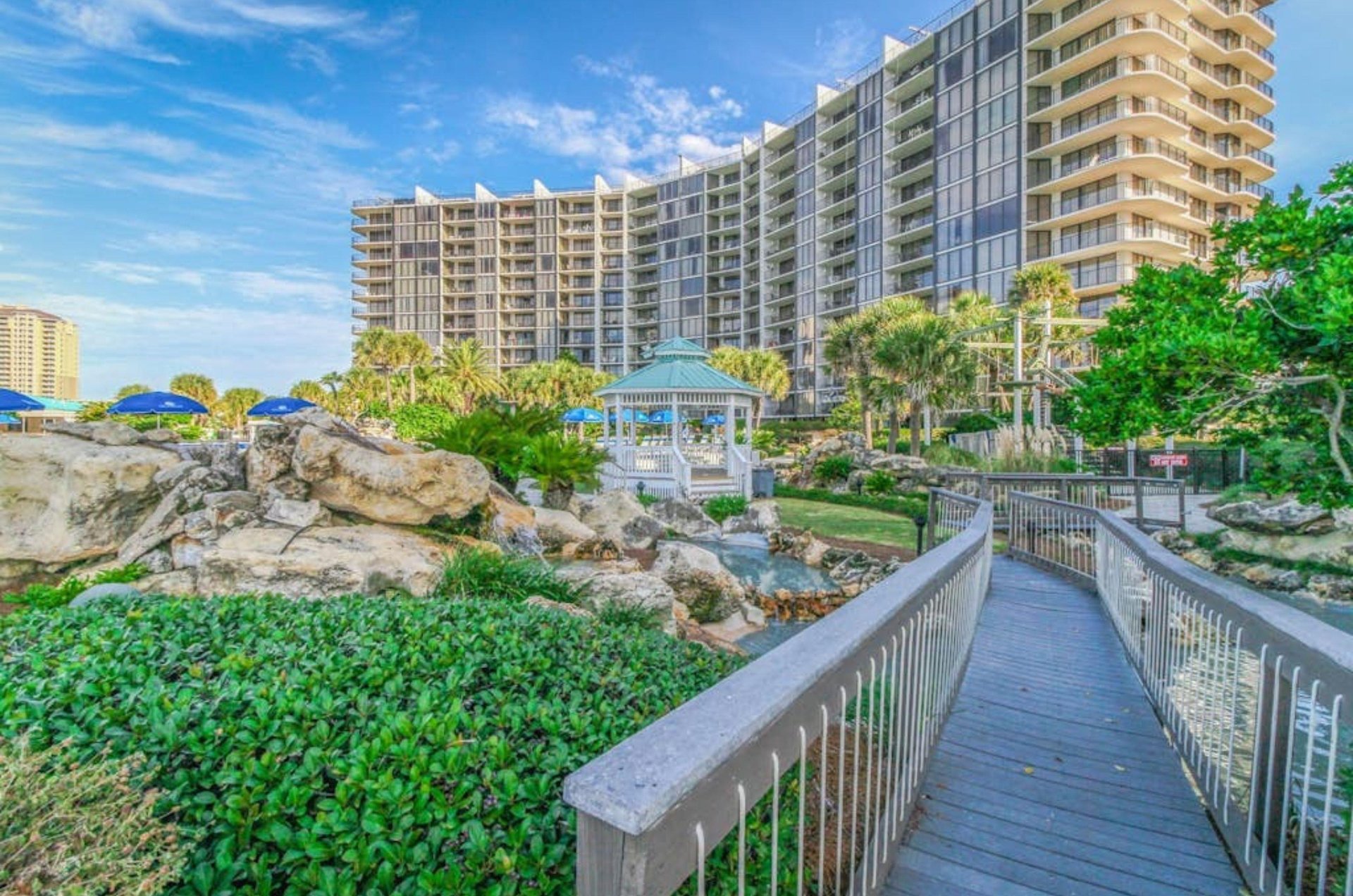 View from the beach of the walkway leading towards Edgewater Beach and Golf Resort